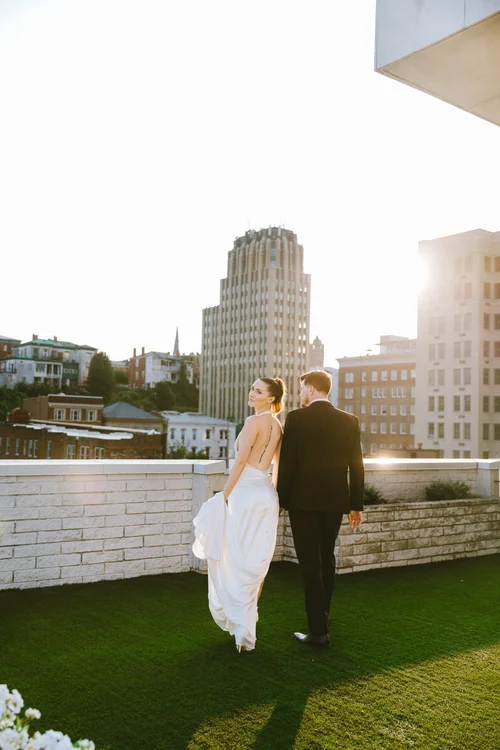 Bride and groom walking in a modern city photography