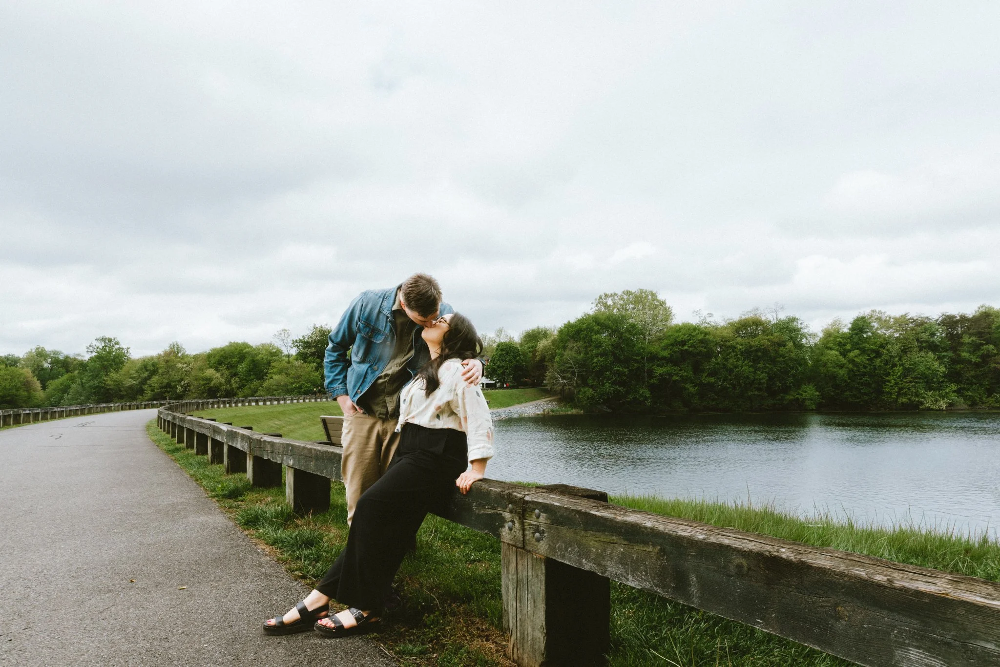  Mariel and Ryan kissing beside the wooden bridge at Inspiration Lake, Kentlands Green Gaithersburg 