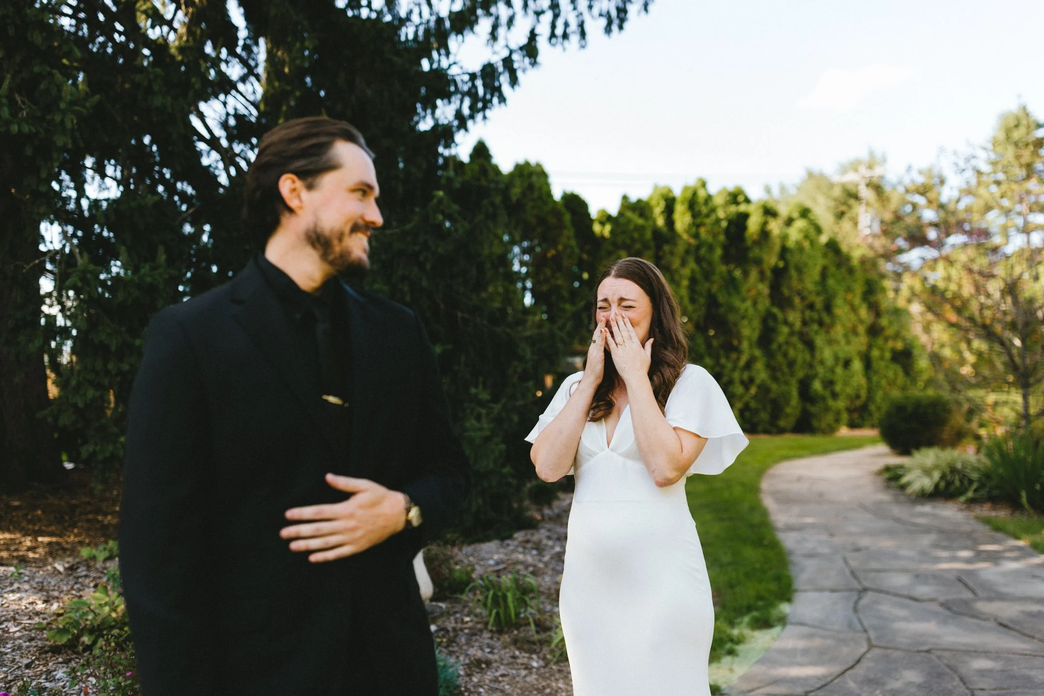 Bride covering her mouth in surprise and joy during first look moment