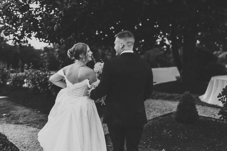 Bride laughing joyfully during outdoor wedding ceremony, documentary wedding photography by Love Story By Aira