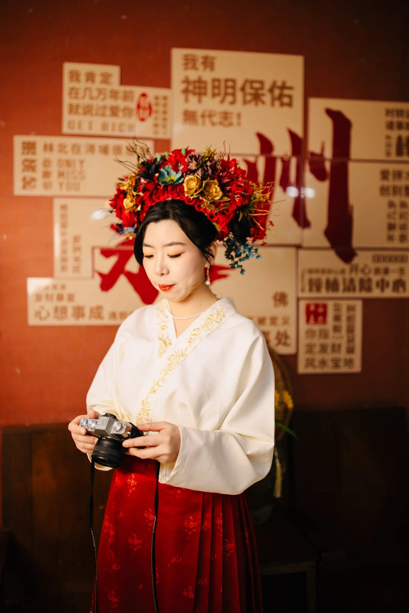 Aira in traditional Chinese dress holding camera, Maryland documentary wedding photographer