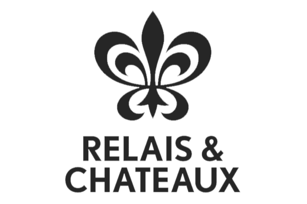 RELAIS & CHATEAUX logo with a stylized fleur-de-lis in bold uppercase letters and in black and white lettering