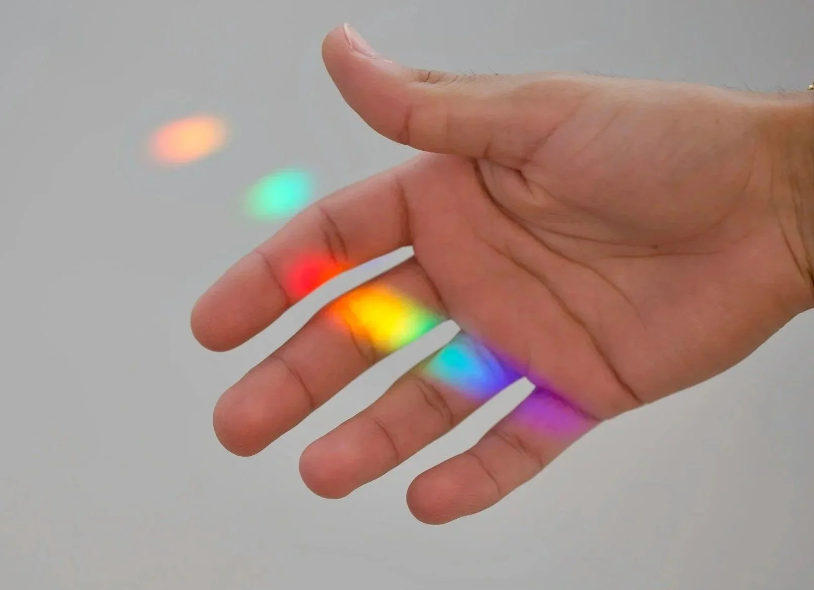 Image representing a rainbow on a hand, signaling LGBTQIA+ affirming therapy in Kansas City, Missouri