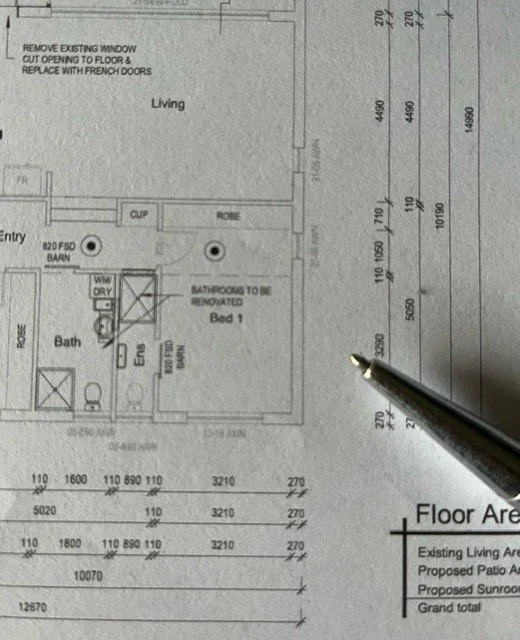 Architectural floor plan showing a living room, bathroom, bedroom, closet, and entry area with measurements and notes for renovations and replacements.