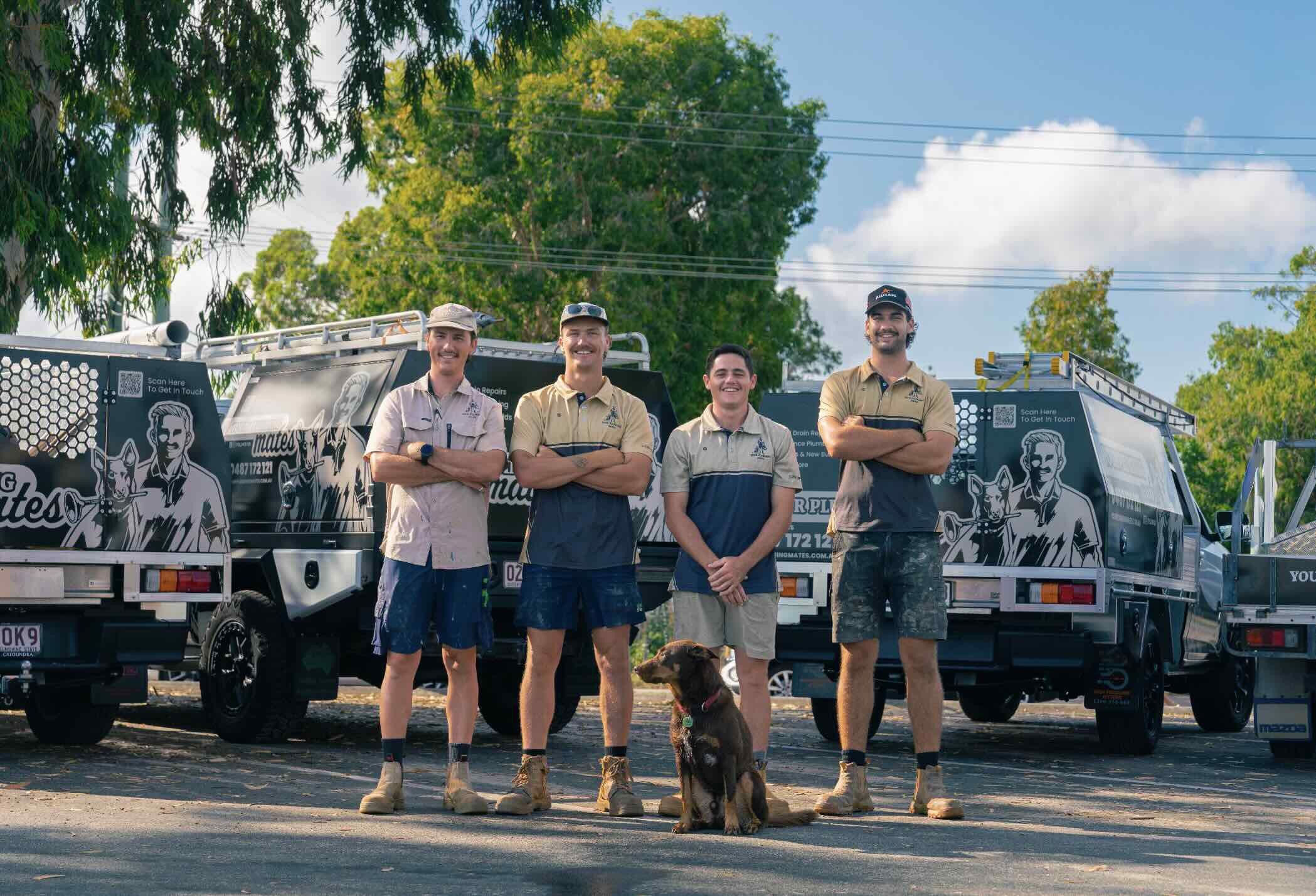 Photo of four your plumbing mates plumbers standing in front of your your plumbing mates vehicles in noosa heads