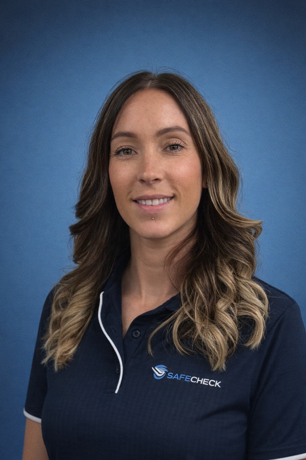 Person wearing a yellow and blue work shirt with a blue background.