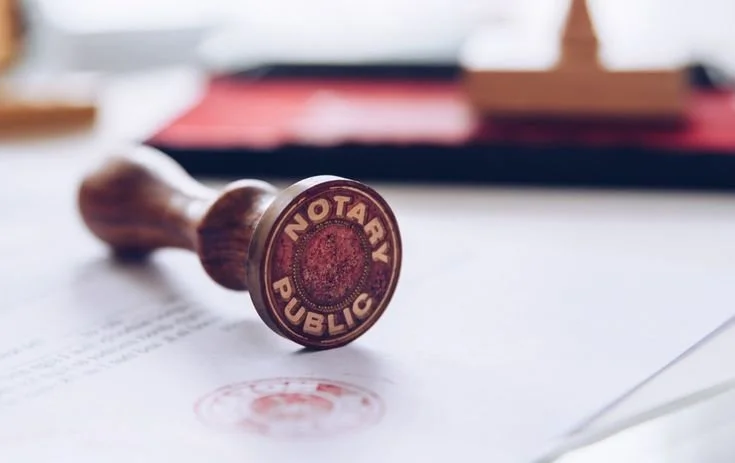 A rubber stamp with the text 'Notary Public' on a sheet of paper.