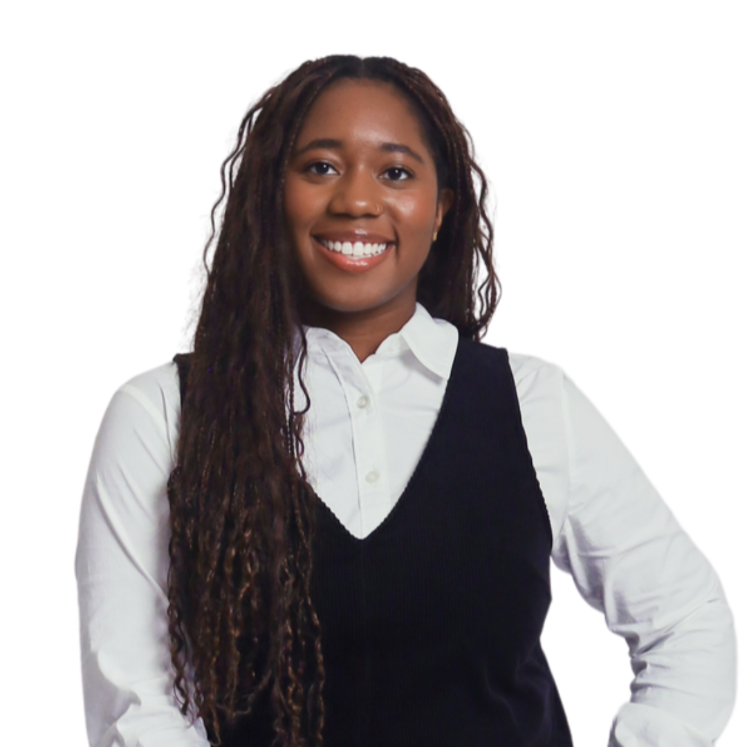 A young woman with braided hair, wearing a black sleeveless button-up shirt, smiling at the camera against a plain white background.