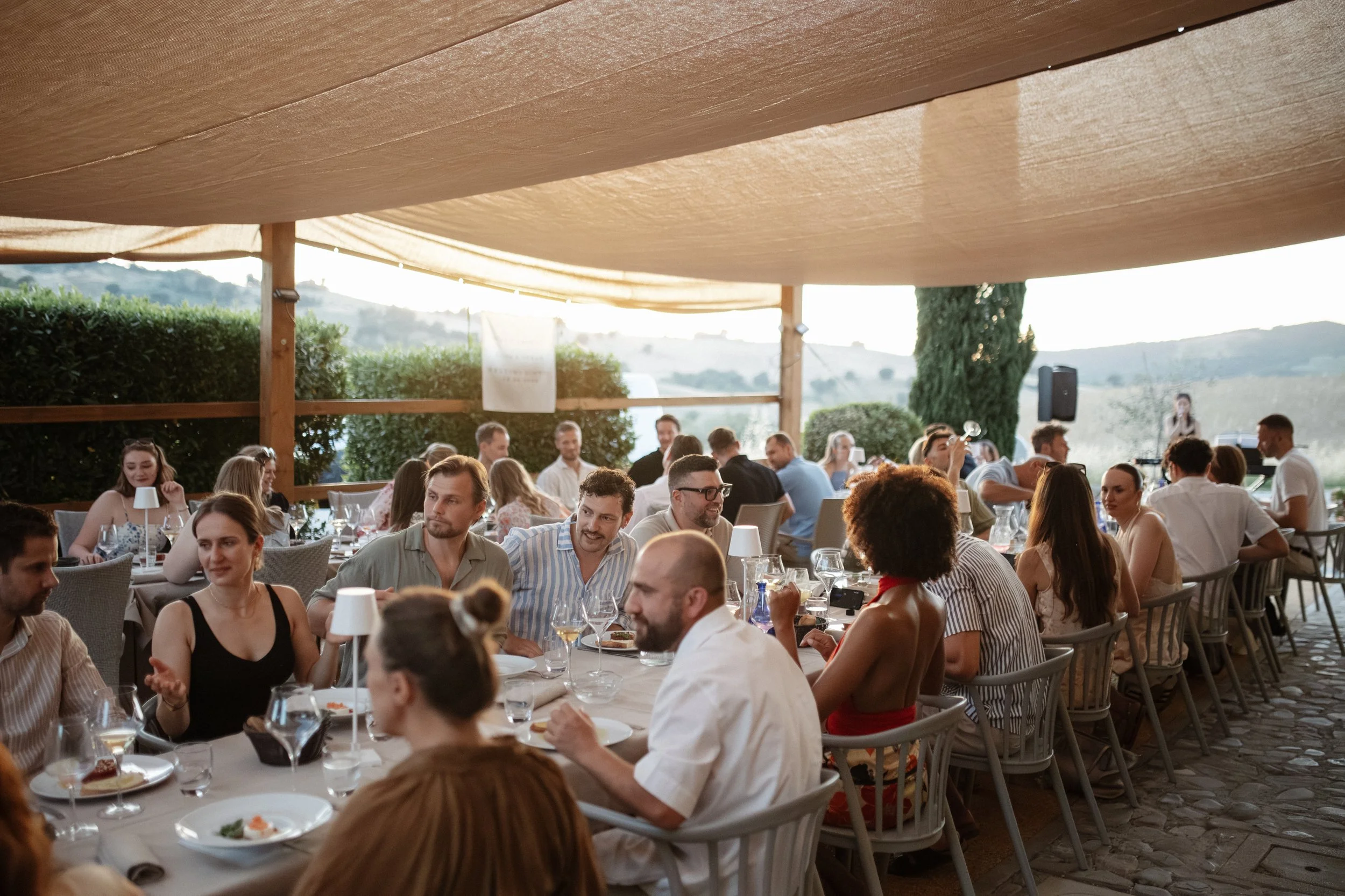 Welcome Dinner in Tuscany at Ristorante La Dispensa in Pomarance, Italy, with an intimate group of friends and family enjoying a relaxed Italian evening.