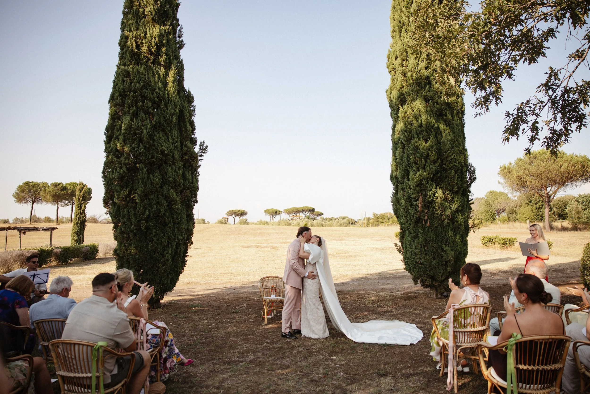 Elegant outdoor wedding ceremony at Casale Sant’Antonio near Rome, with Selina and Jamie exchanging personal vows during their Italian destination wedding.