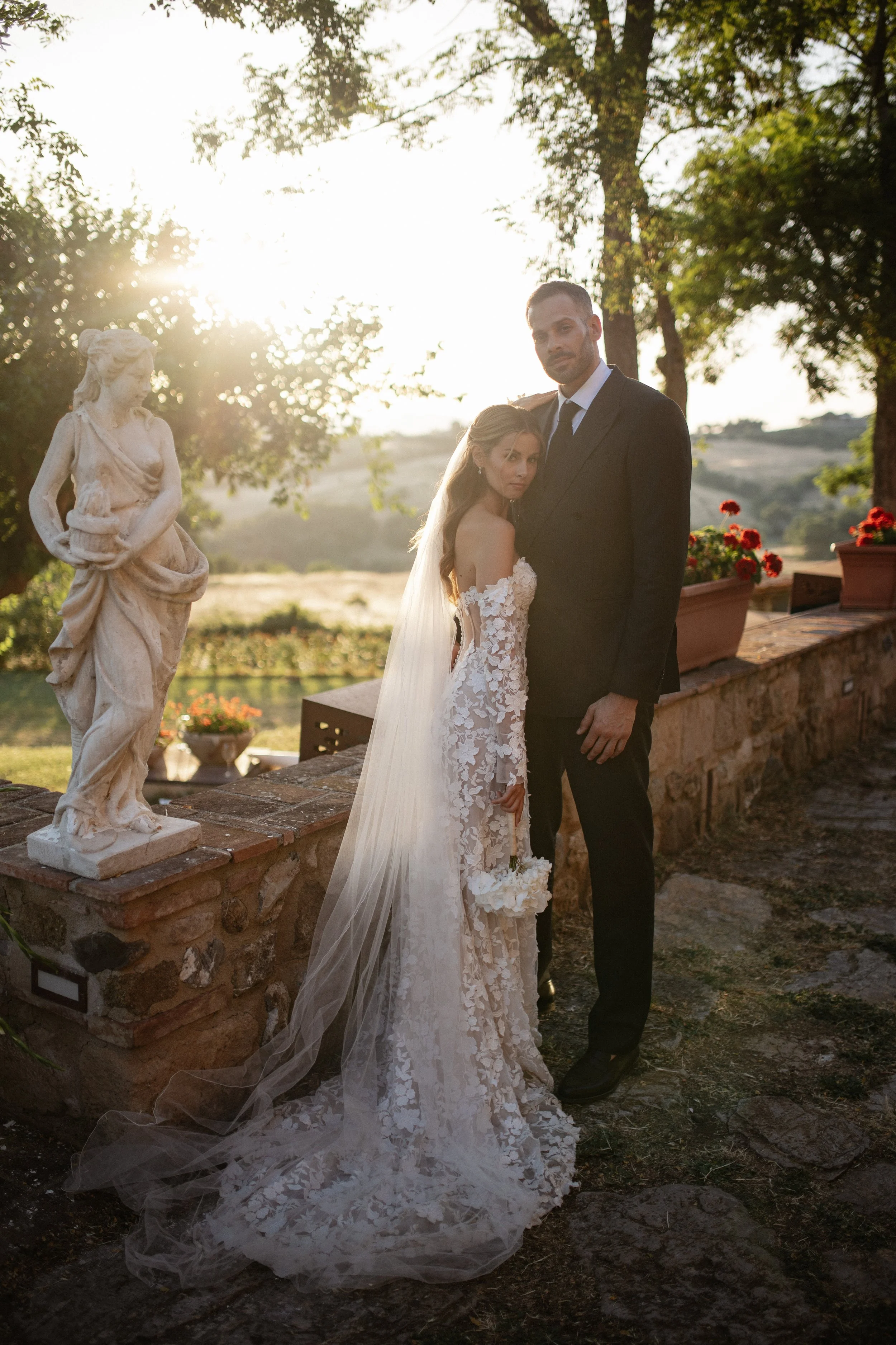 Elegant Tuscany wedding couple portraits in the warm Italian evening light, combining the rustic architecture and natural landscape of Lustignano with a timeless wedding aesthetic.