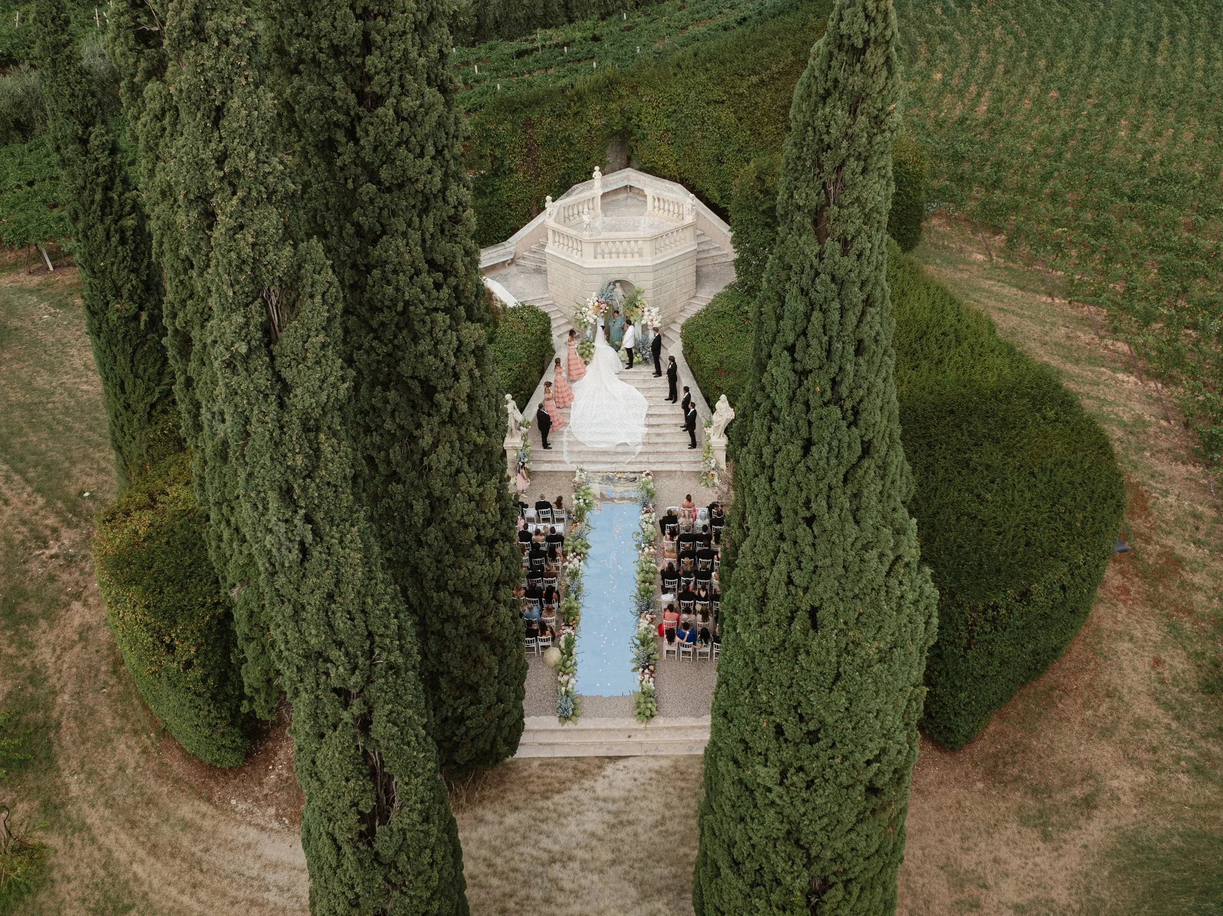 Luxury wedding ceremony in the historic gardens of Villa Rizzardi in Verona, with elegant floral styling, white details and a sophisticated Italian garden setting.