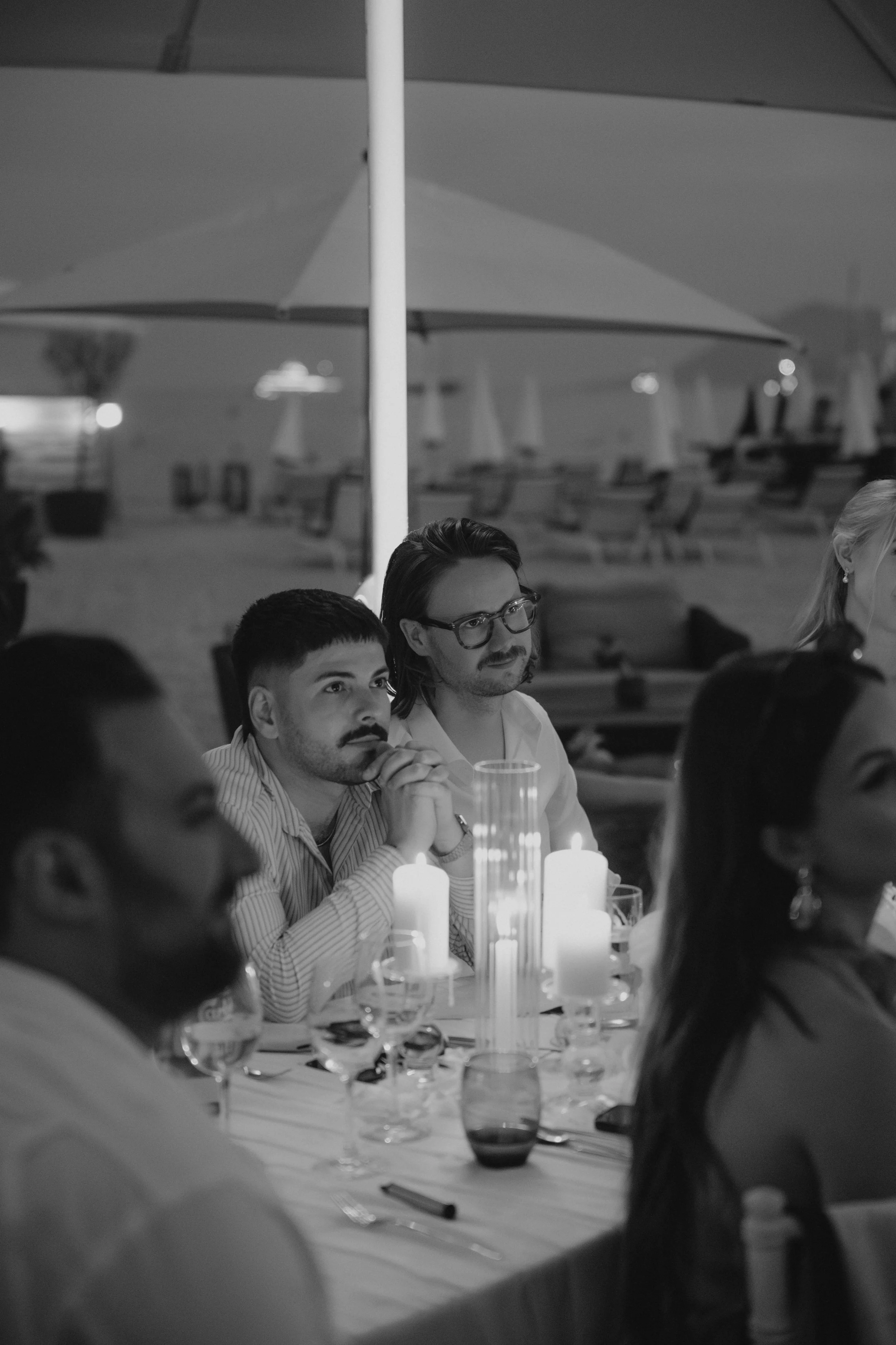 Luxury wedding dinner and reception by the Mediterranean Sea in Cannes, featuring elegant tablescape design, white florals, heartfelt speeches, candlelight, and an intimate celebration on the French Riviera.