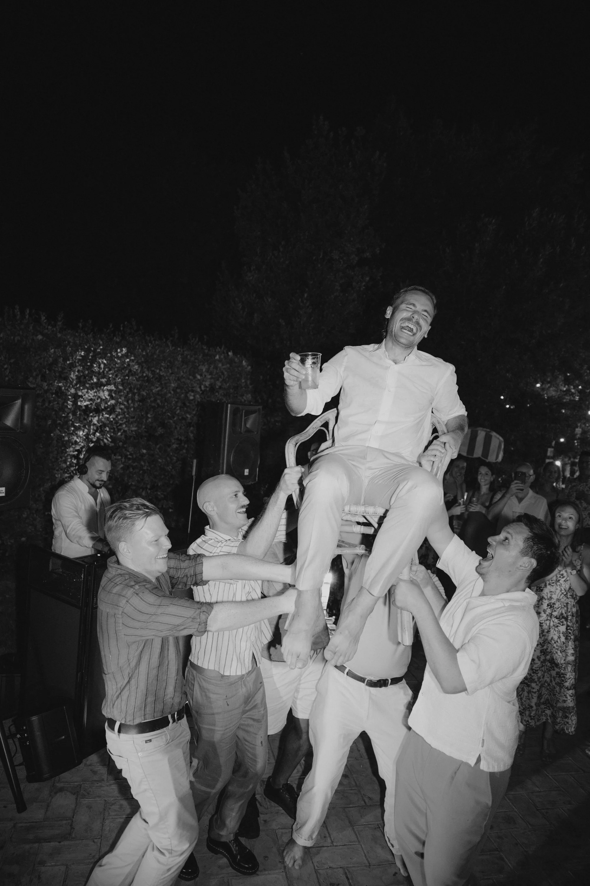 Selina, Jamie and their guests dancing, enjoying ice cream and jumping into the pool at Casale del Gallo during a relaxed Italian summer wedding party.