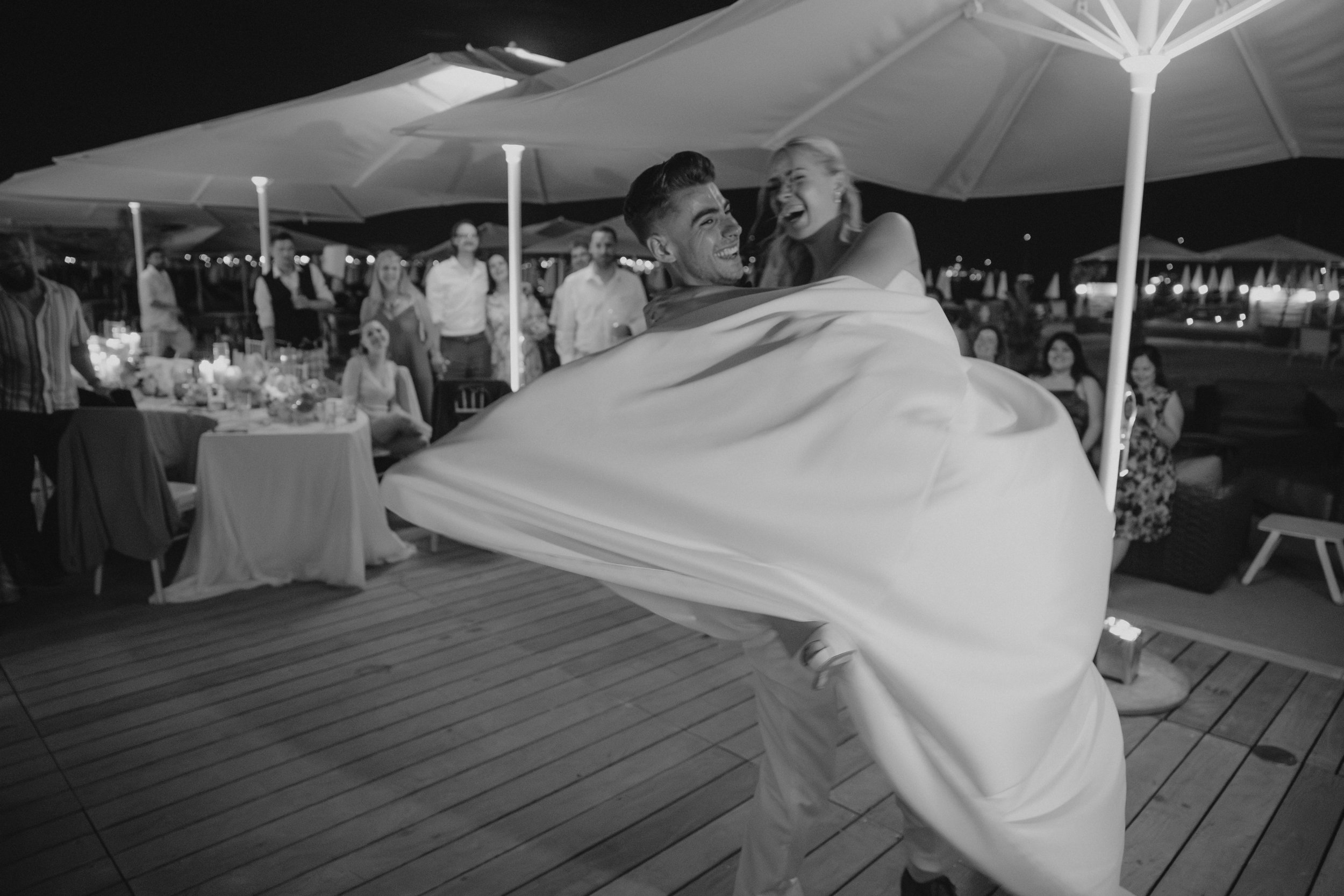Luxury wedding dinner and reception by the Mediterranean Sea in Cannes, featuring elegant tablescape design, white florals, heartfelt speeches, candlelight, and an intimate celebration on the French Riviera.