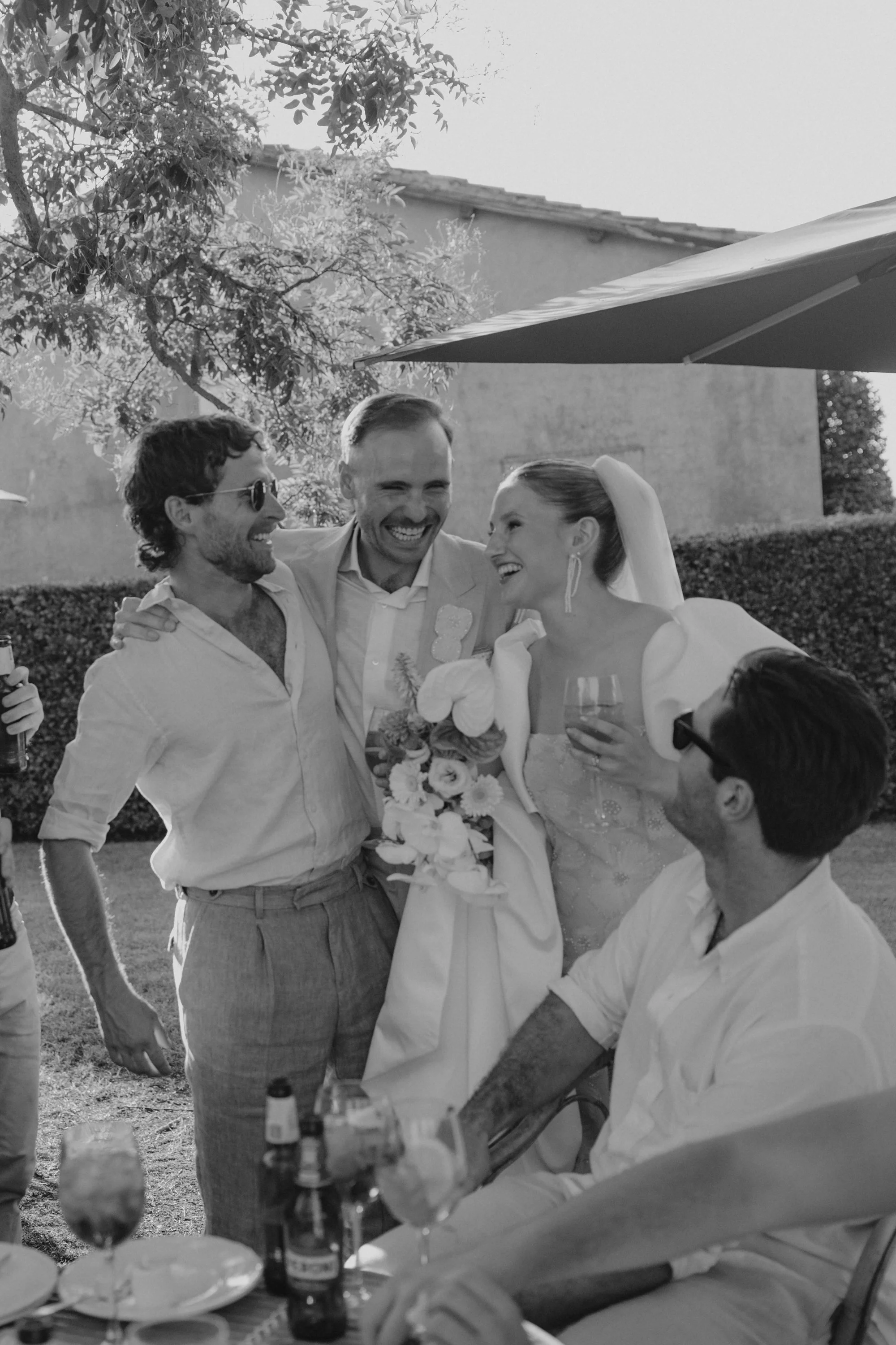 Italian summer wedding at Casale del Gallo near Rome, featuring Selina’s individual wedding dress by Lieben Achten Ehren, her statement cape and Jamie’s rose-colored suit.