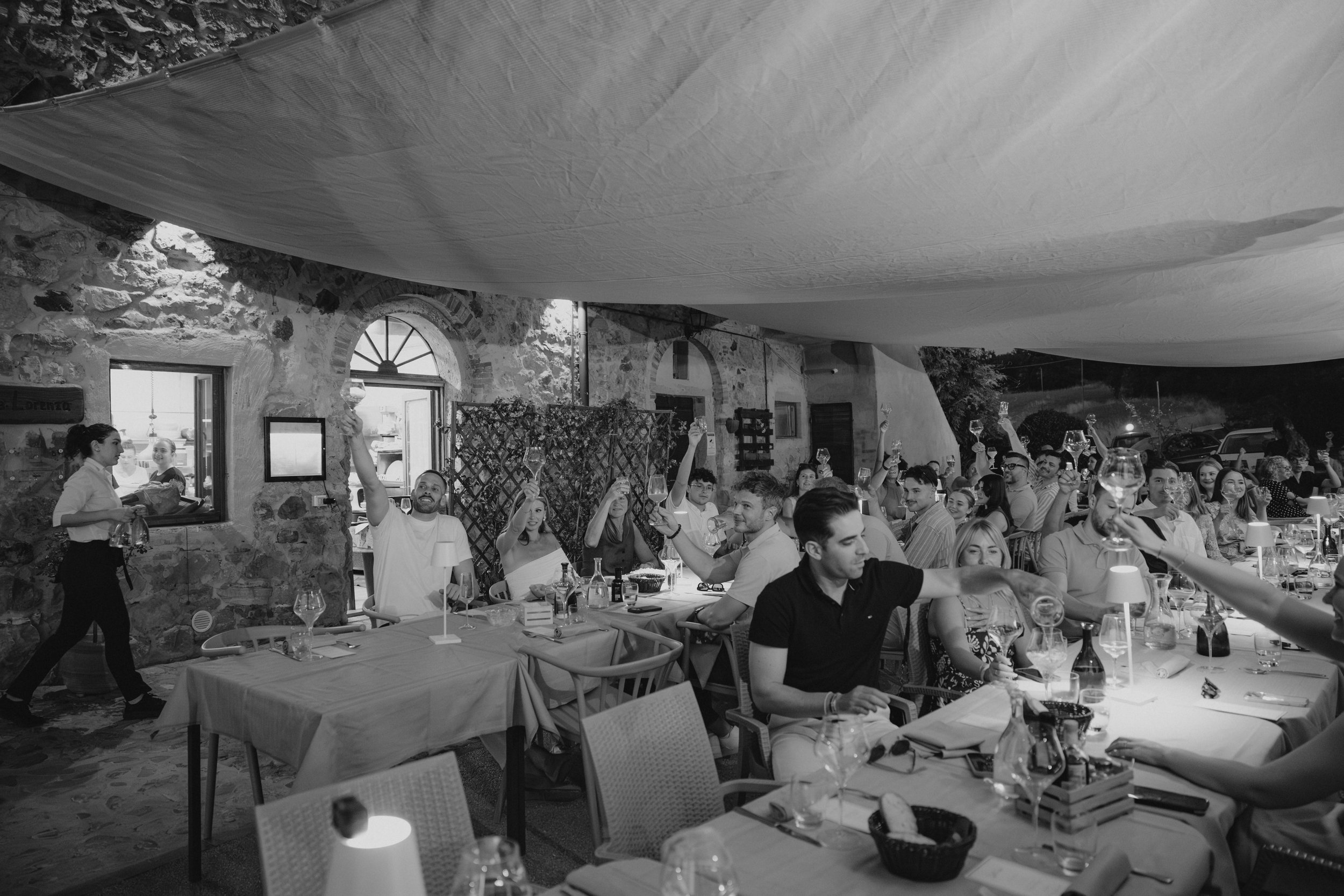 Welcome Dinner in Tuscany at Ristorante La Dispensa in Pomarance, Italy, with an intimate group of friends and family enjoying a relaxed Italian evening.