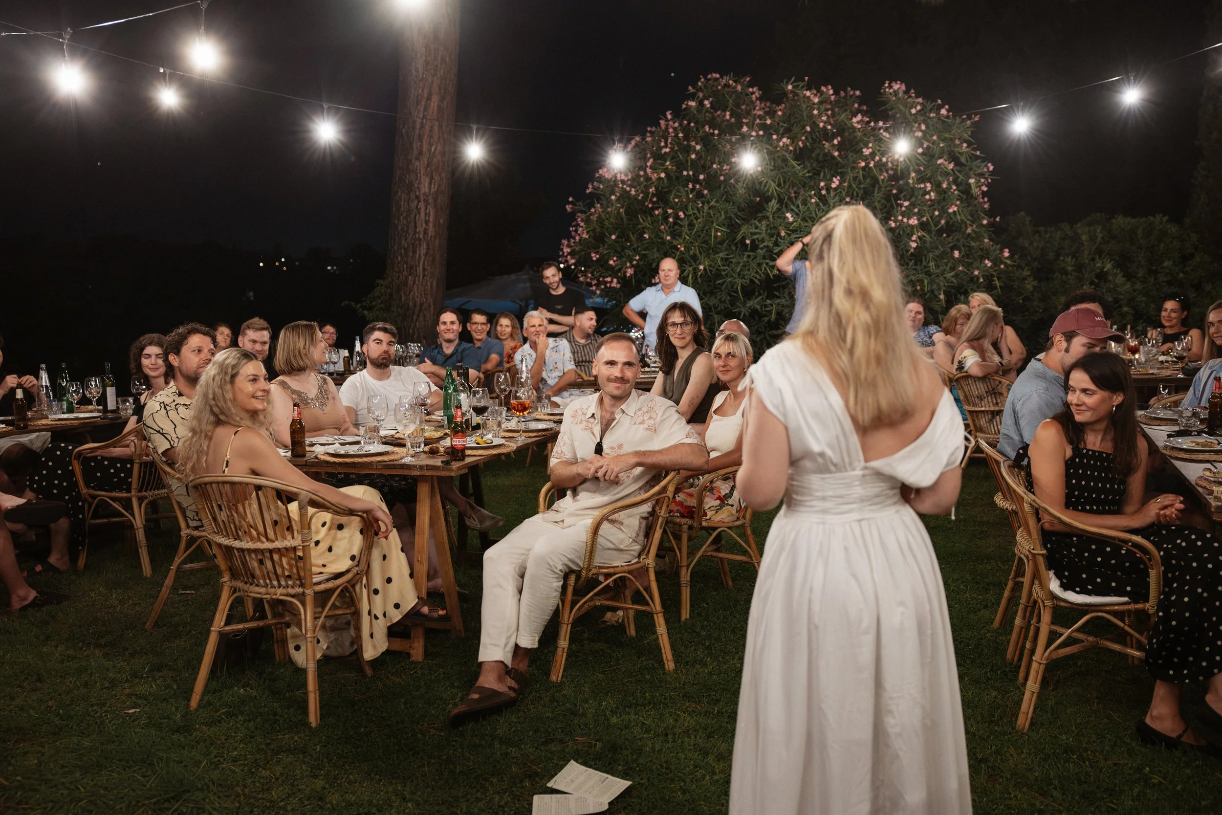 Relaxed welcome dinner at Casale del Gallo in Rome, with Selina and Jamie celebrating with their guests over pizza on a warm Italian summer evening.