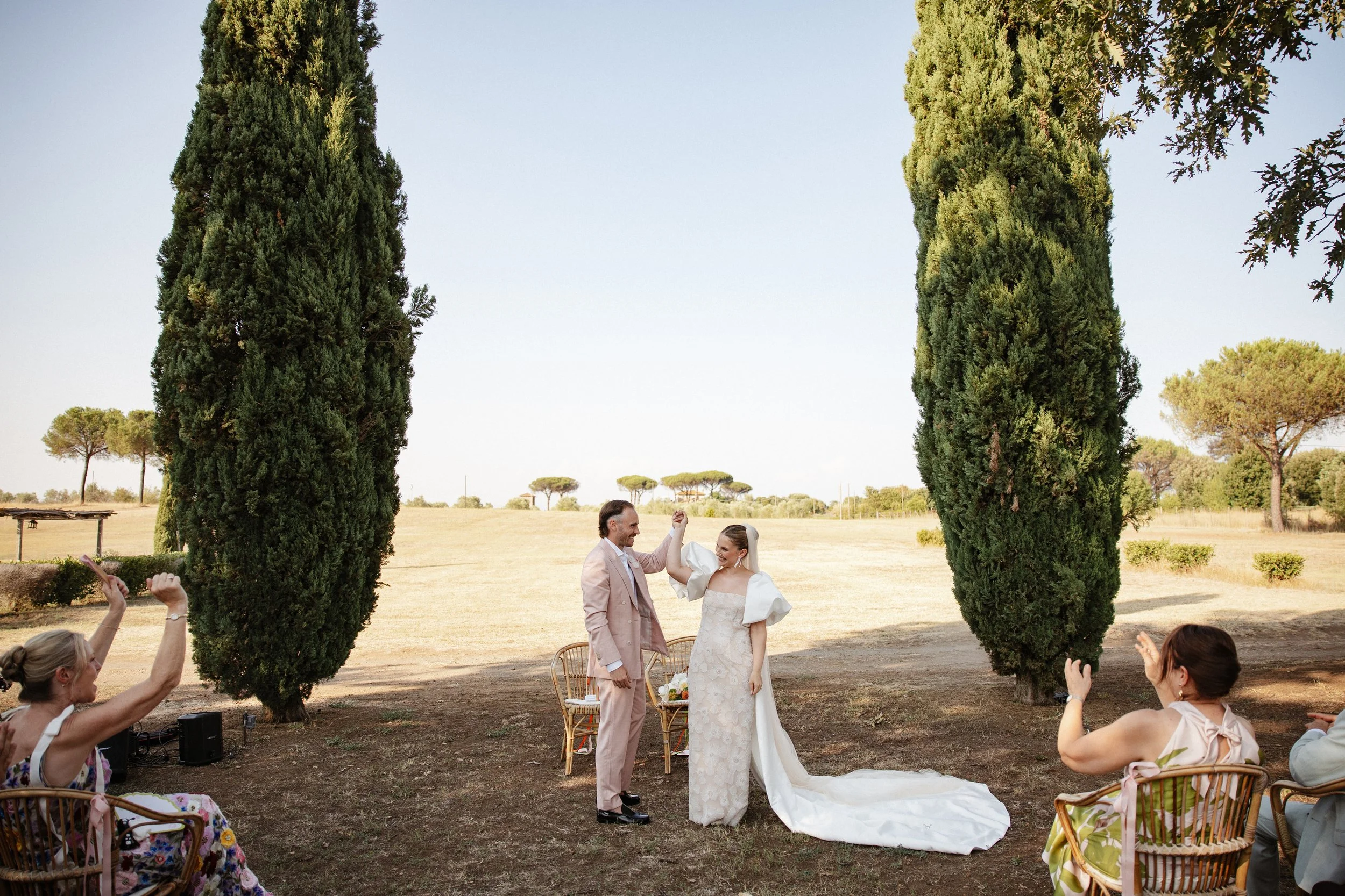 Elegant outdoor wedding ceremony at Casale Sant’Antonio near Rome, with Selina and Jamie exchanging personal vows during their Italian destination wedding.