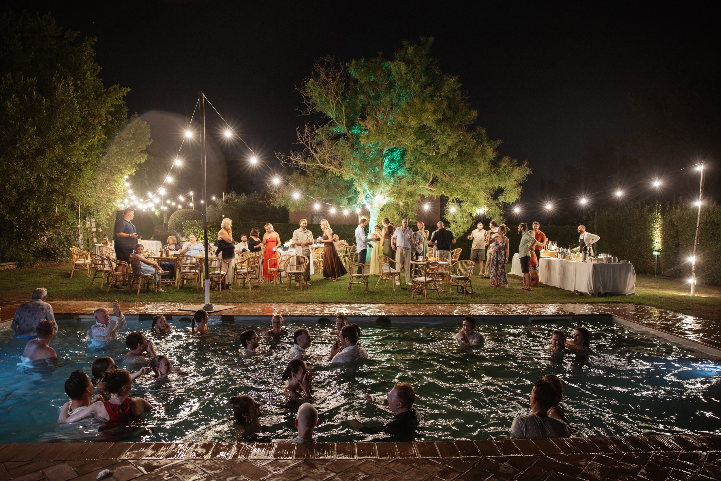 Selina, Jamie and their guests dancing, enjoying ice cream and jumping into the pool at Casale del Gallo during a relaxed Italian summer wedding party.