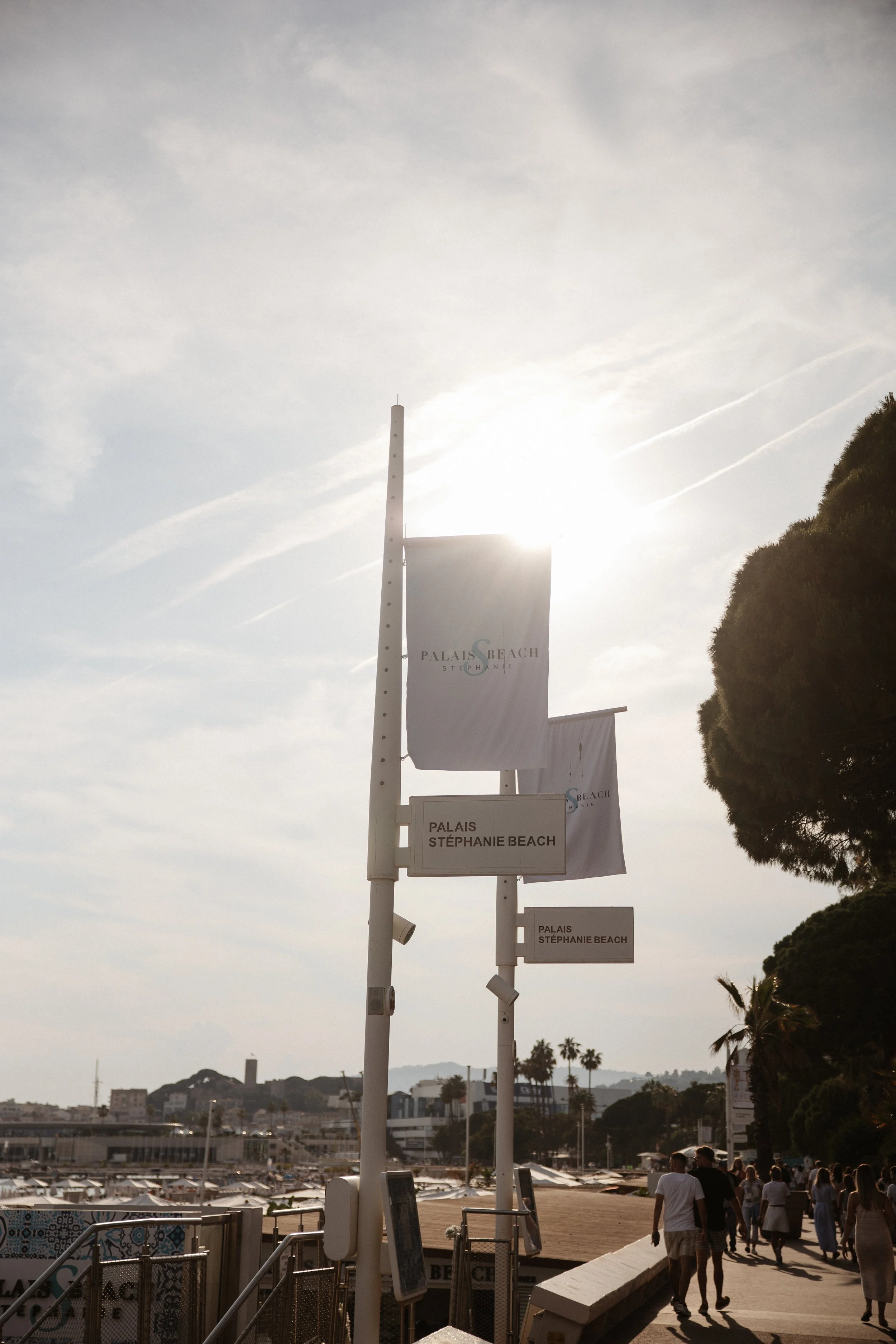 Elegant wedding portraits of the bride and groom along Boulevard de la Croisette in Cannes, featuring a white tuxedo, timeless bridal fashion, Mediterranean architecture, and the iconic French Riviera atmosphere.