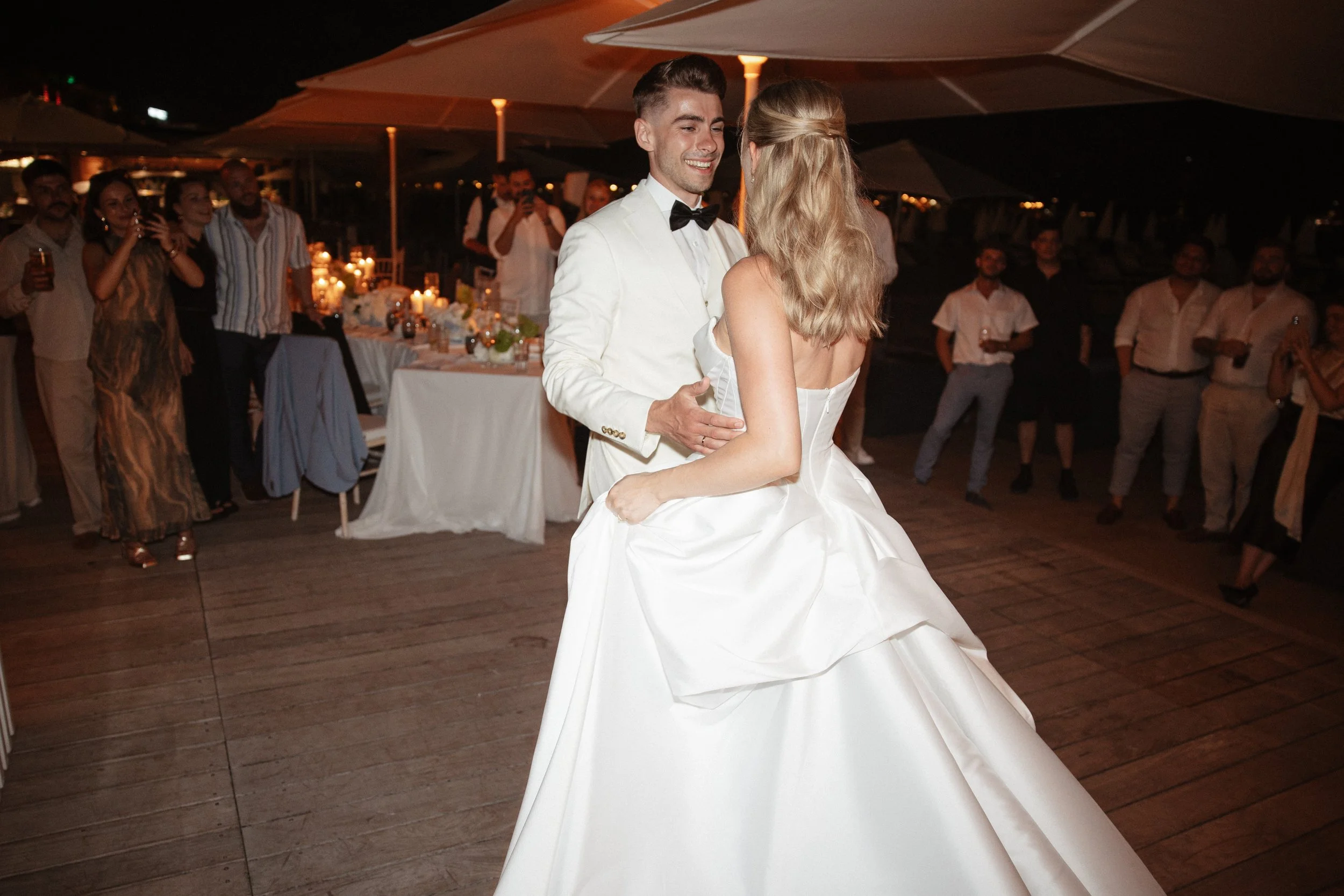 Luxury wedding dinner and reception by the Mediterranean Sea in Cannes, featuring elegant tablescape design, white florals, heartfelt speeches, candlelight, and an intimate celebration on the French Riviera.