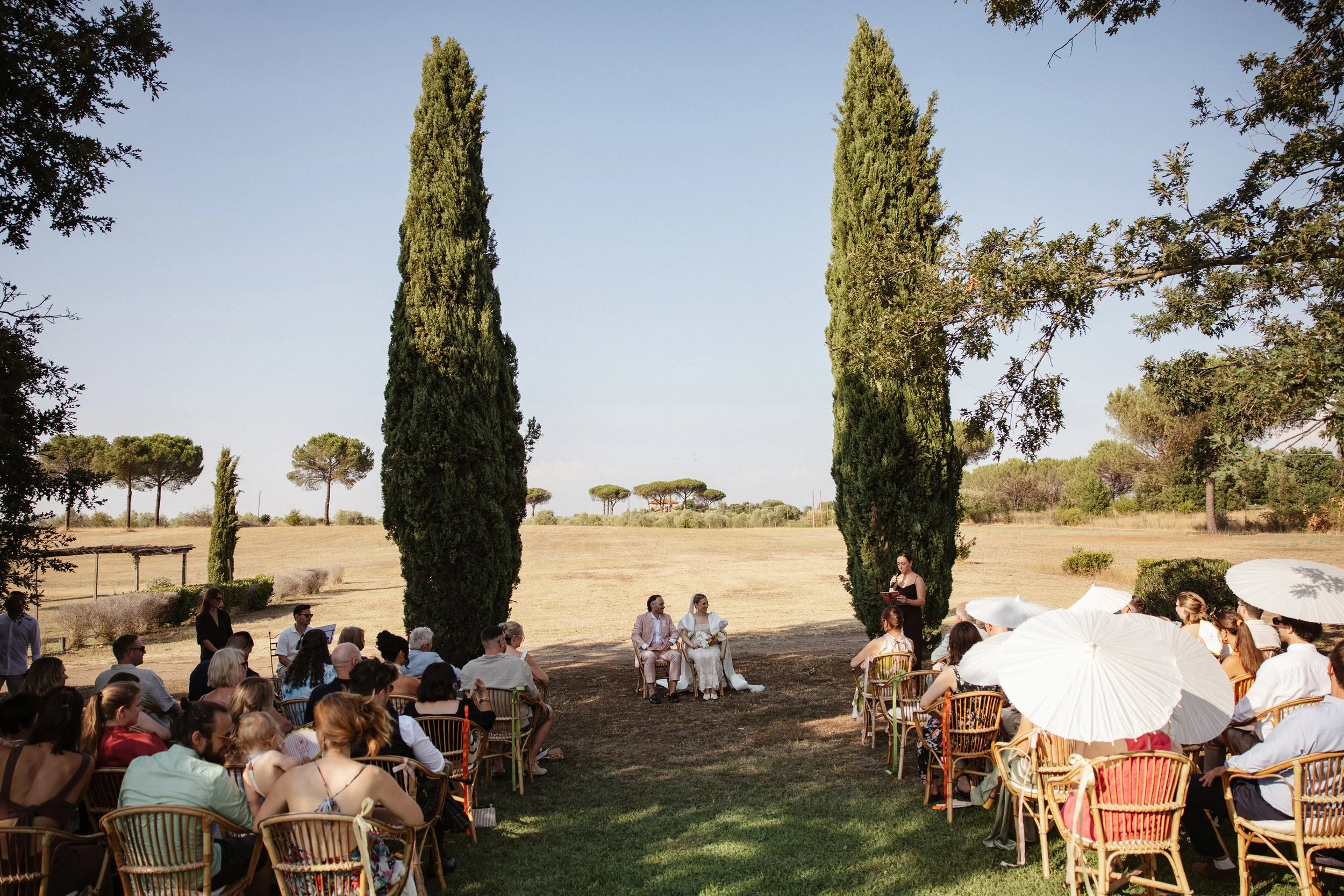 Elegant outdoor wedding ceremony at Casale Sant’Antonio near Rome, with Selina and Jamie exchanging personal vows during their Italian destination wedding.