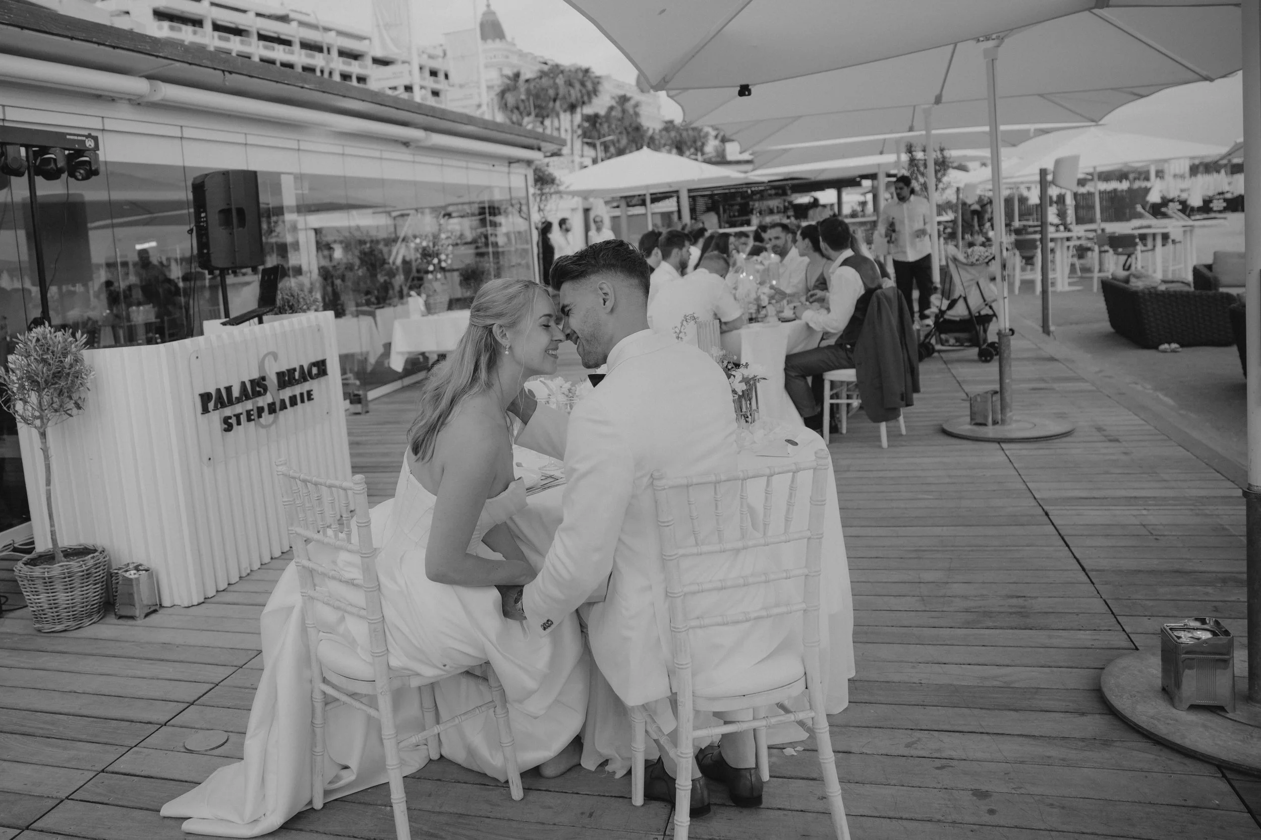 Luxury wedding dinner and reception by the Mediterranean Sea in Cannes, featuring elegant tablescape design, white florals, heartfelt speeches, candlelight, and an intimate celebration on the French Riviera.