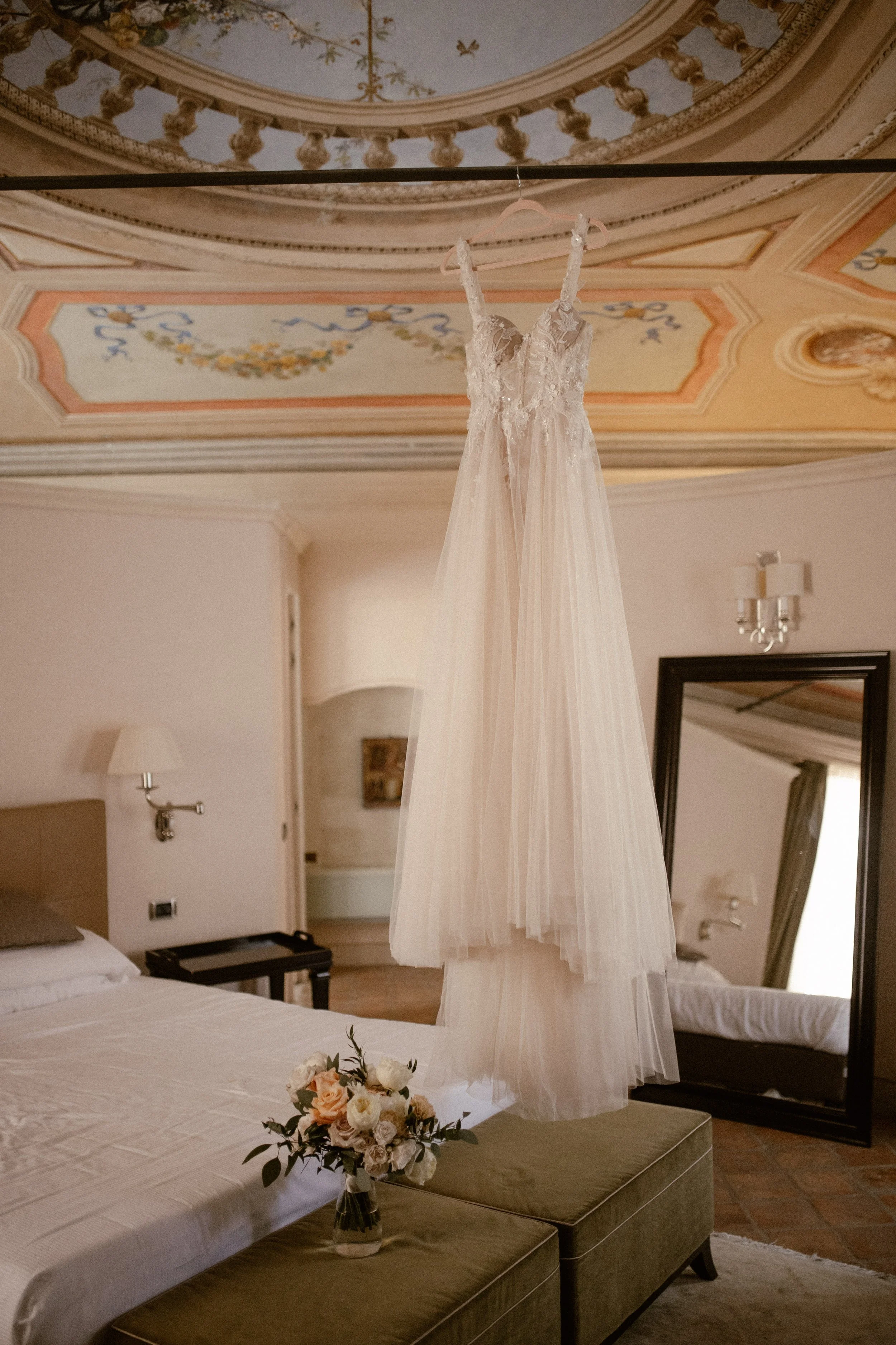 Getting Ready for Bride and Groom in the Hotel Room of Relais Sant Uffzie in Piedmont, Italy. Wooden Chairs and Vintage Metal Wedding Arch decorated with Eucalyptus and White Fabric.