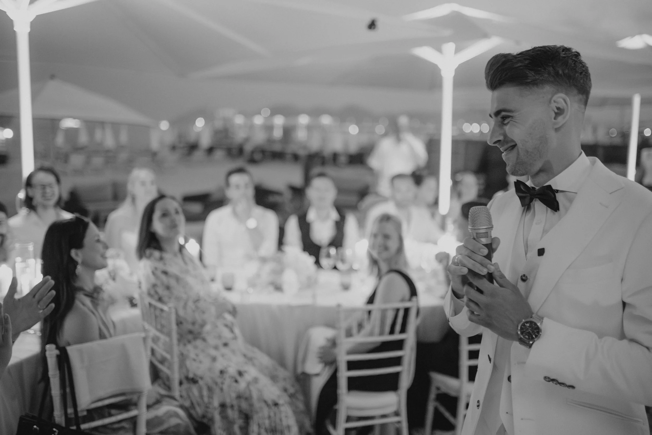 Luxury wedding dinner and reception by the Mediterranean Sea in Cannes, featuring elegant tablescape design, white florals, heartfelt speeches, candlelight, and an intimate celebration on the French Riviera.