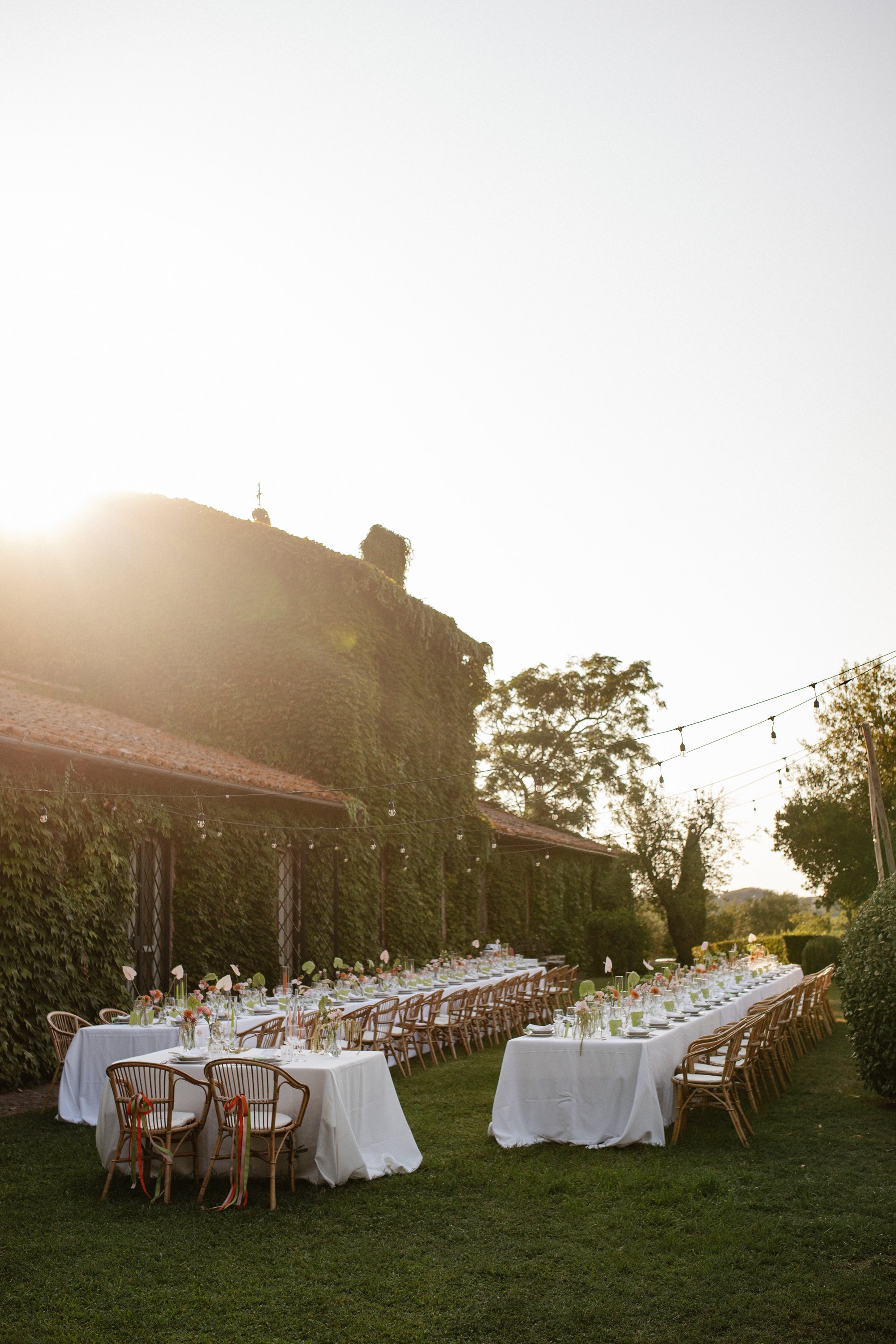 Italian summer wedding at Casale del Gallo near Rome, featuring Selina’s individual wedding dress by Lieben Achten Ehren, her statement cape and Jamie’s rose-colored suit.