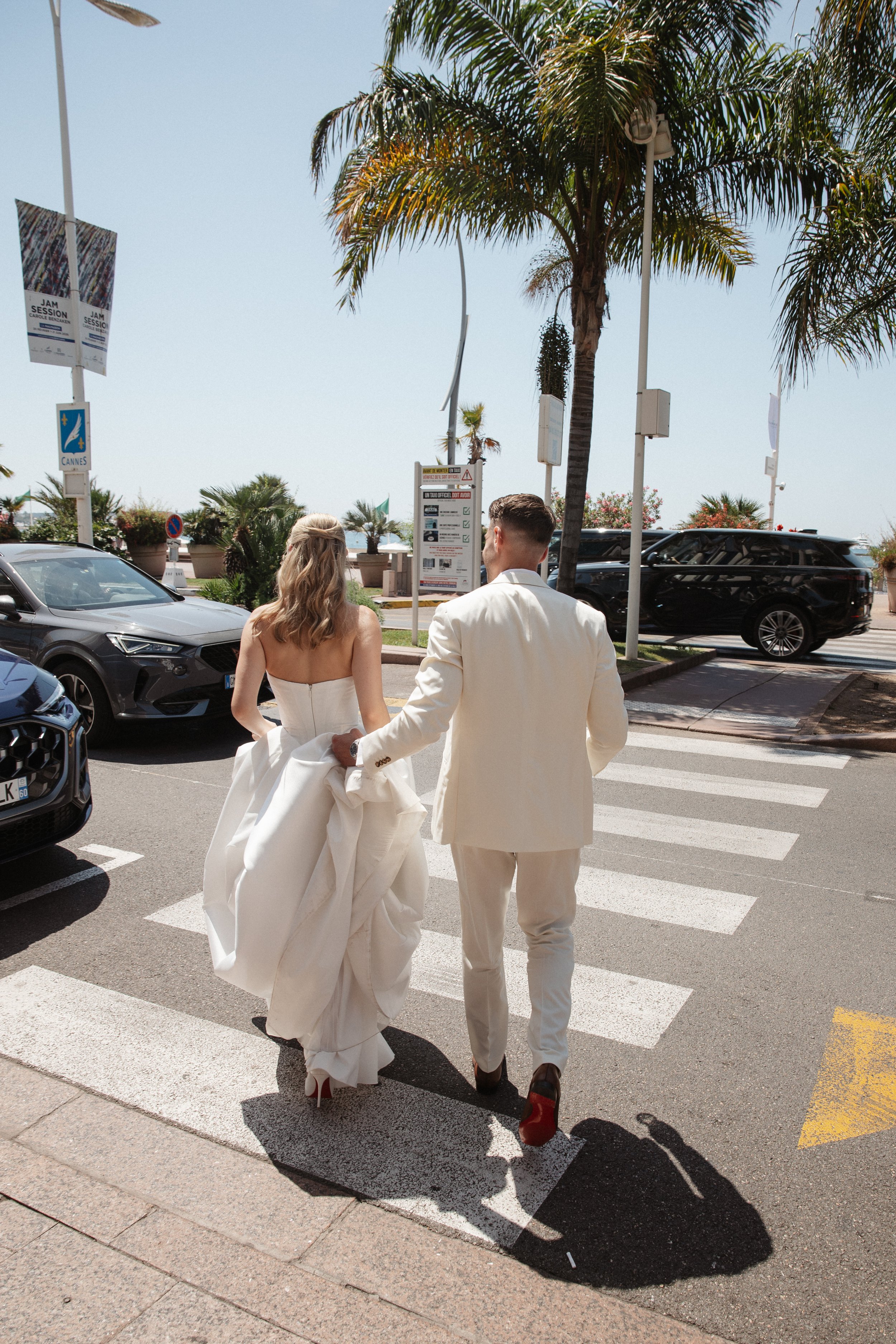 Outdoor wedding ceremony at Stephanie Beach in Cannes overlooking the Mediterranean Sea, surrounded by palm trees and the beautiful coastline of the French Riviera during an intimate luxury wedding.