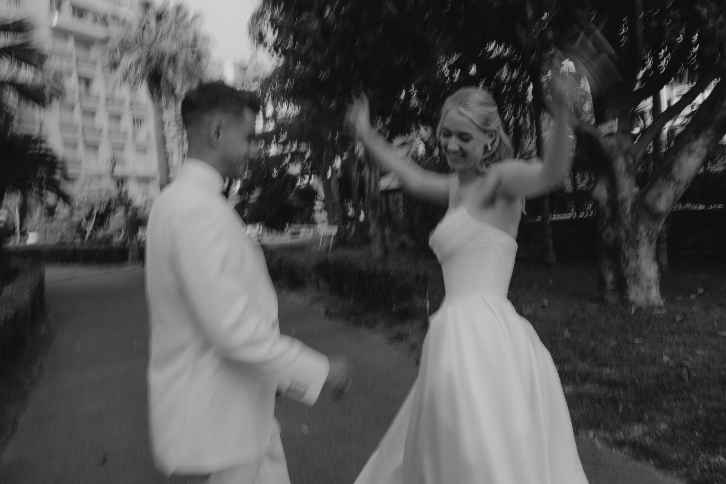 Elegant wedding portraits of the bride and groom along Boulevard de la Croisette in Cannes, featuring a white tuxedo, timeless bridal fashion, Mediterranean architecture, and the iconic French Riviera atmosphere.
