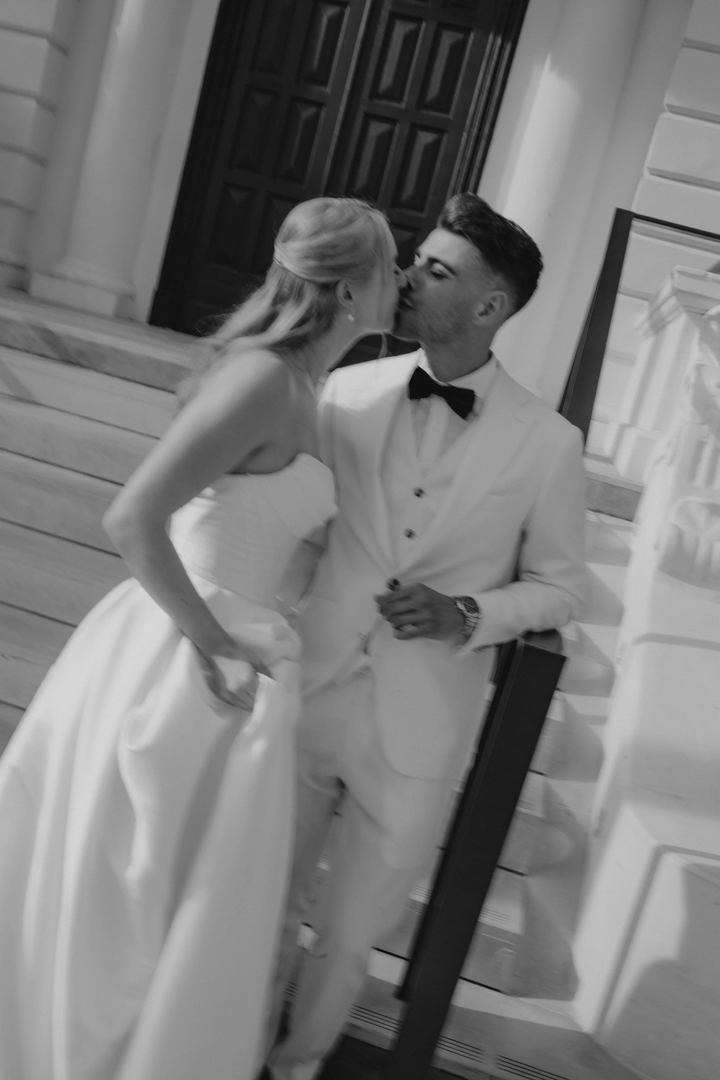 Elegant wedding portraits of the bride and groom along Boulevard de la Croisette in Cannes, featuring a white tuxedo, timeless bridal fashion, Mediterranean architecture, and the iconic French Riviera atmosphere.