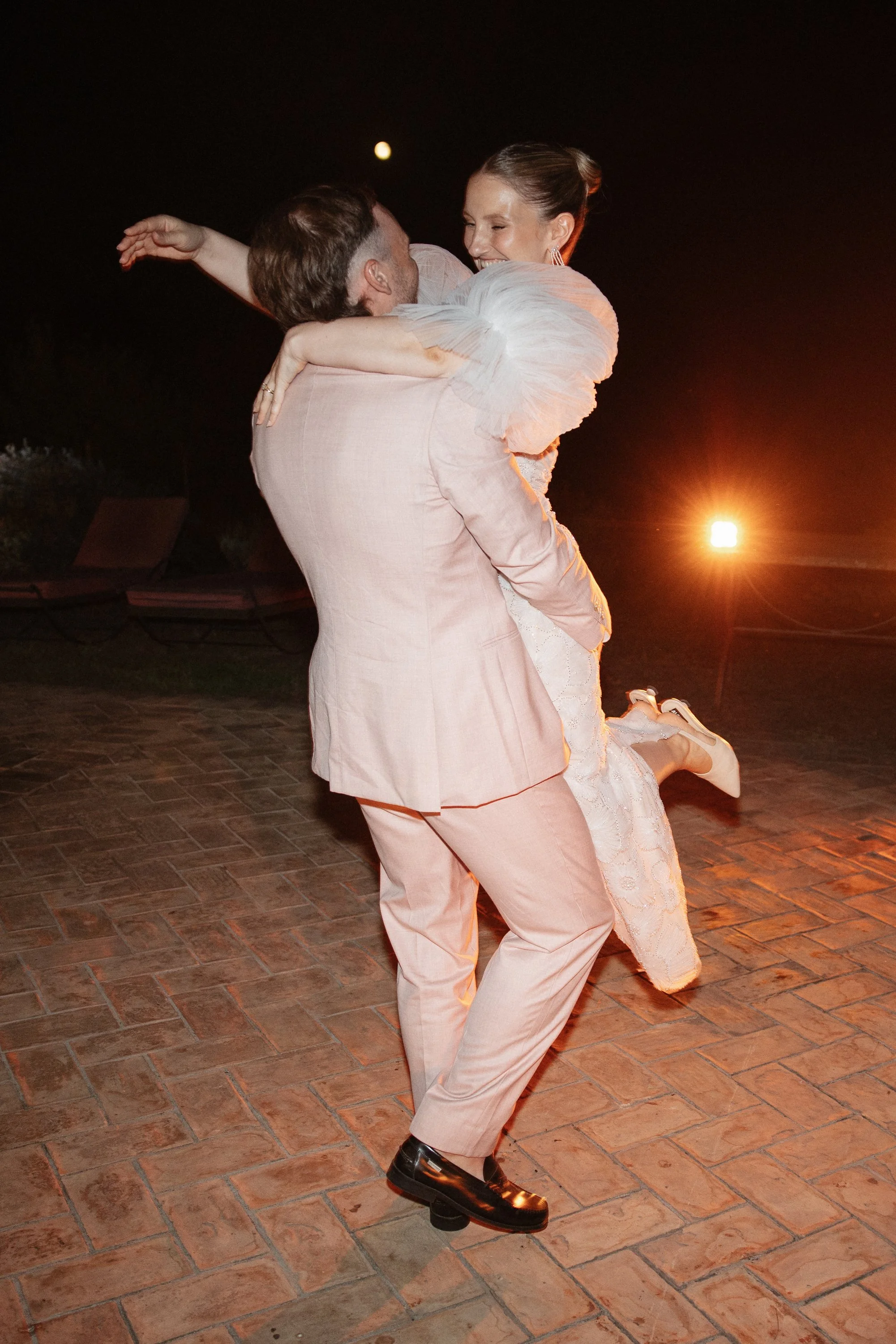 Selina, Jamie and their guests dancing, enjoying ice cream and jumping into the pool at Casale del Gallo during a relaxed Italian summer wedding party.