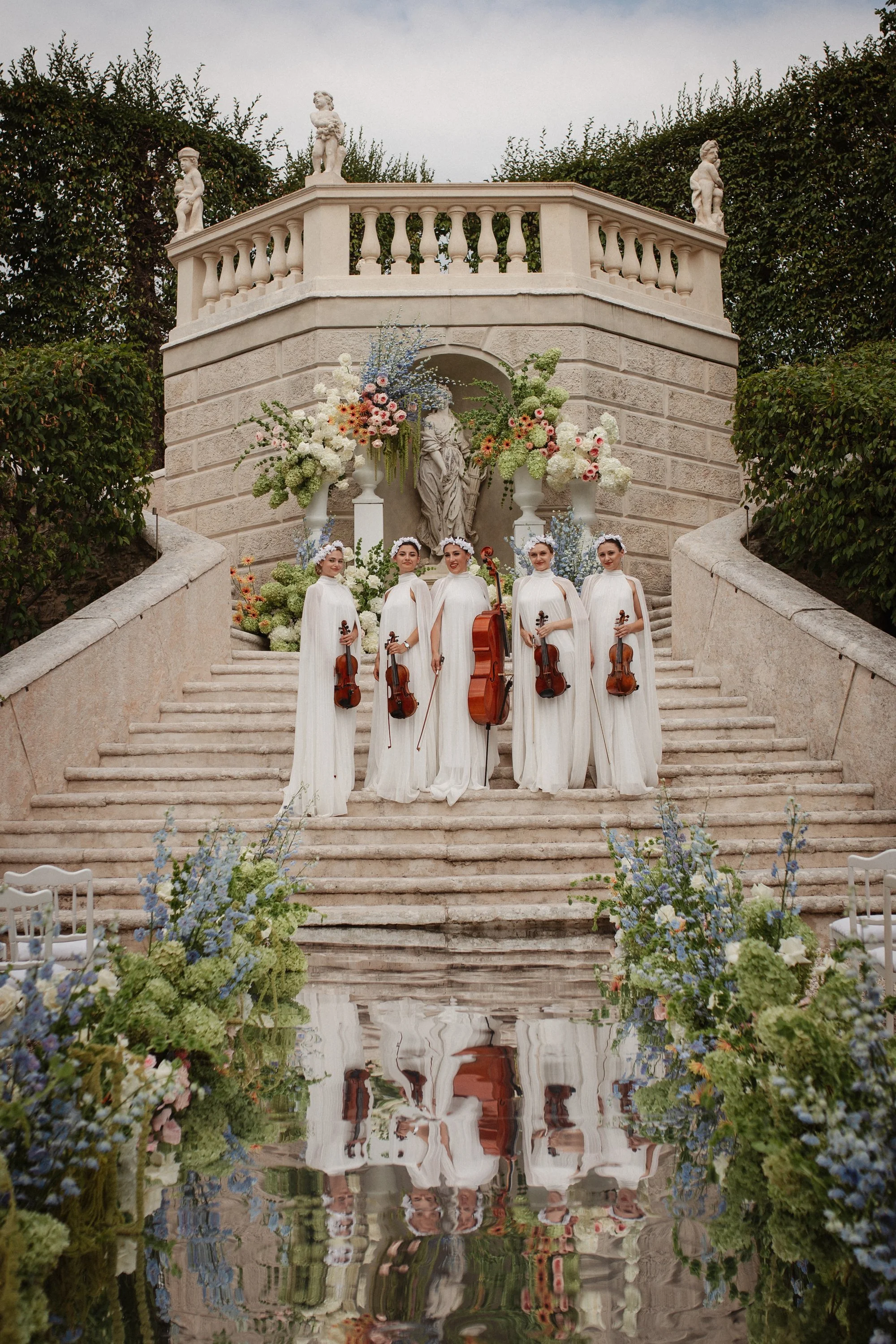 Luxury wedding ceremony in the historic gardens of Villa Rizzardi in Verona, with elegant floral styling, white details and a sophisticated Italian garden setting.