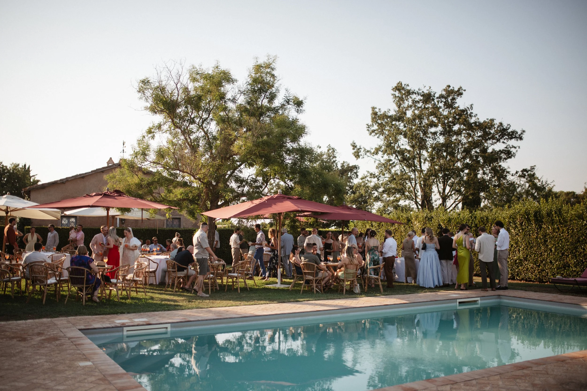 Italian summer wedding at Casale del Gallo near Rome, featuring Selina’s individual wedding dress by Lieben Achten Ehren, her statement cape and Jamie’s rose-colored suit.
