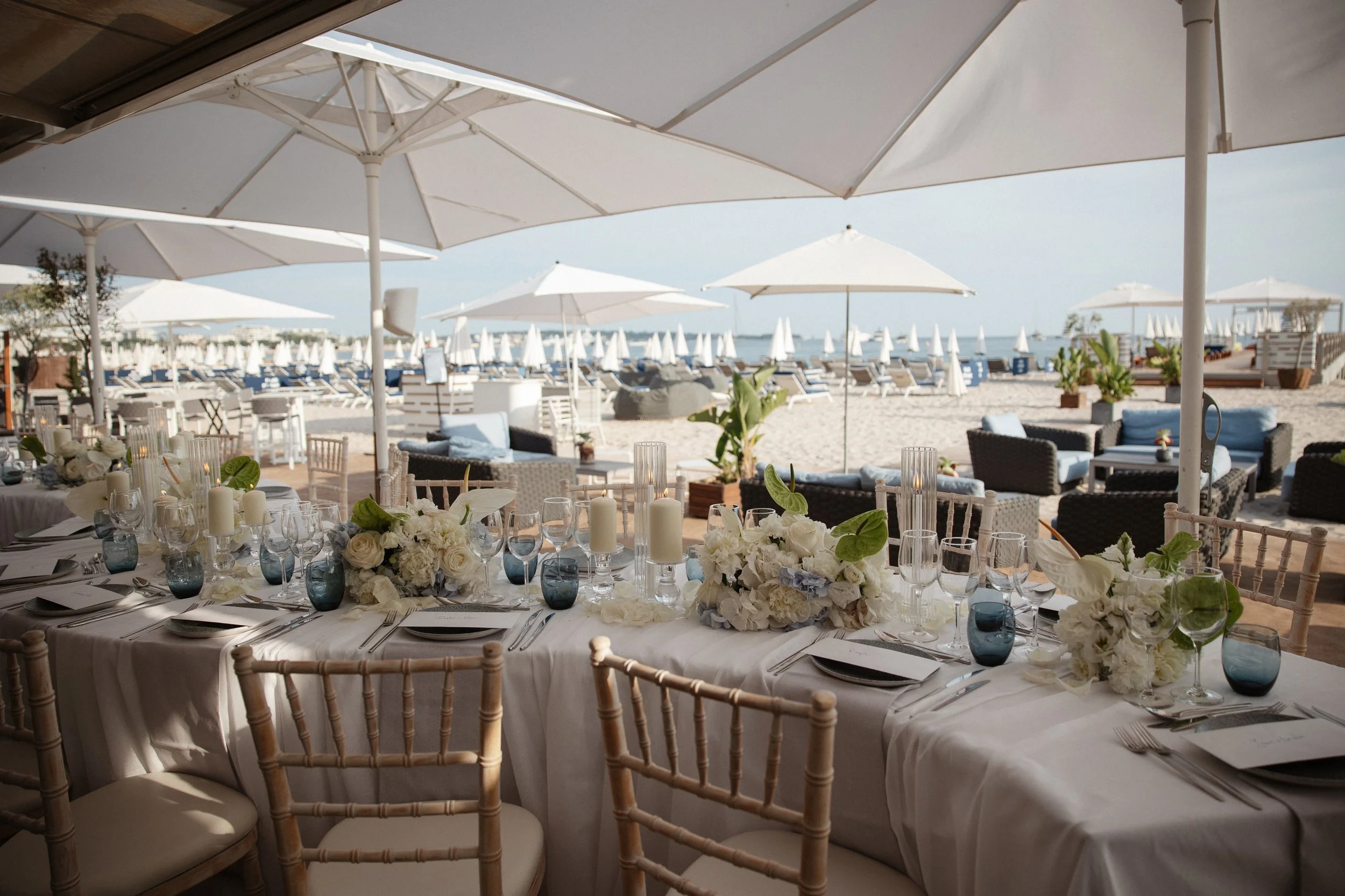 Luxury wedding dinner and reception by the Mediterranean Sea in Cannes, featuring elegant tablescape design, white florals, heartfelt speeches, candlelight, and an intimate celebration on the French Riviera.