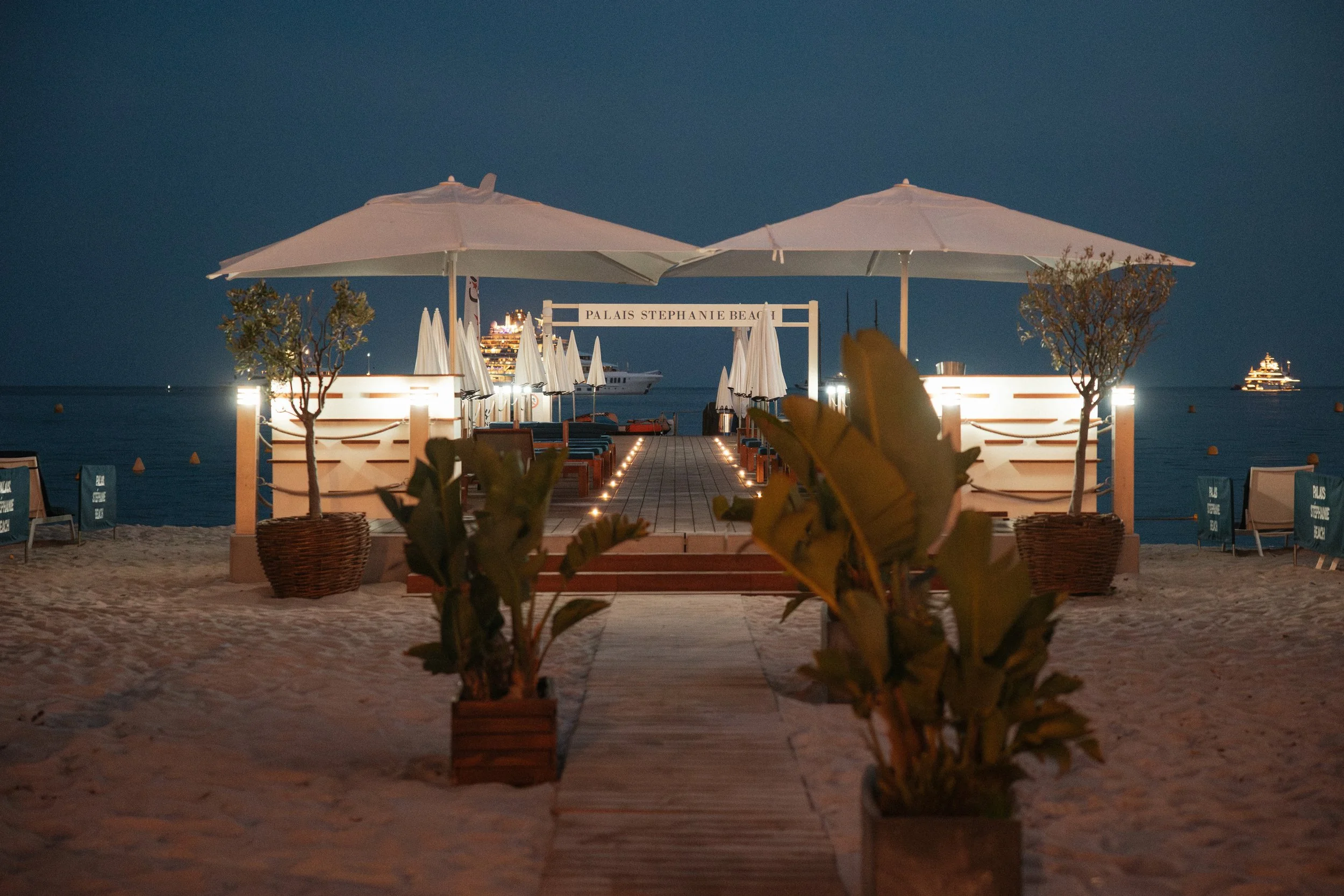Luxury wedding dinner and reception by the Mediterranean Sea in Cannes, featuring elegant tablescape design, white florals, heartfelt speeches, candlelight, and an intimate celebration on the French Riviera.