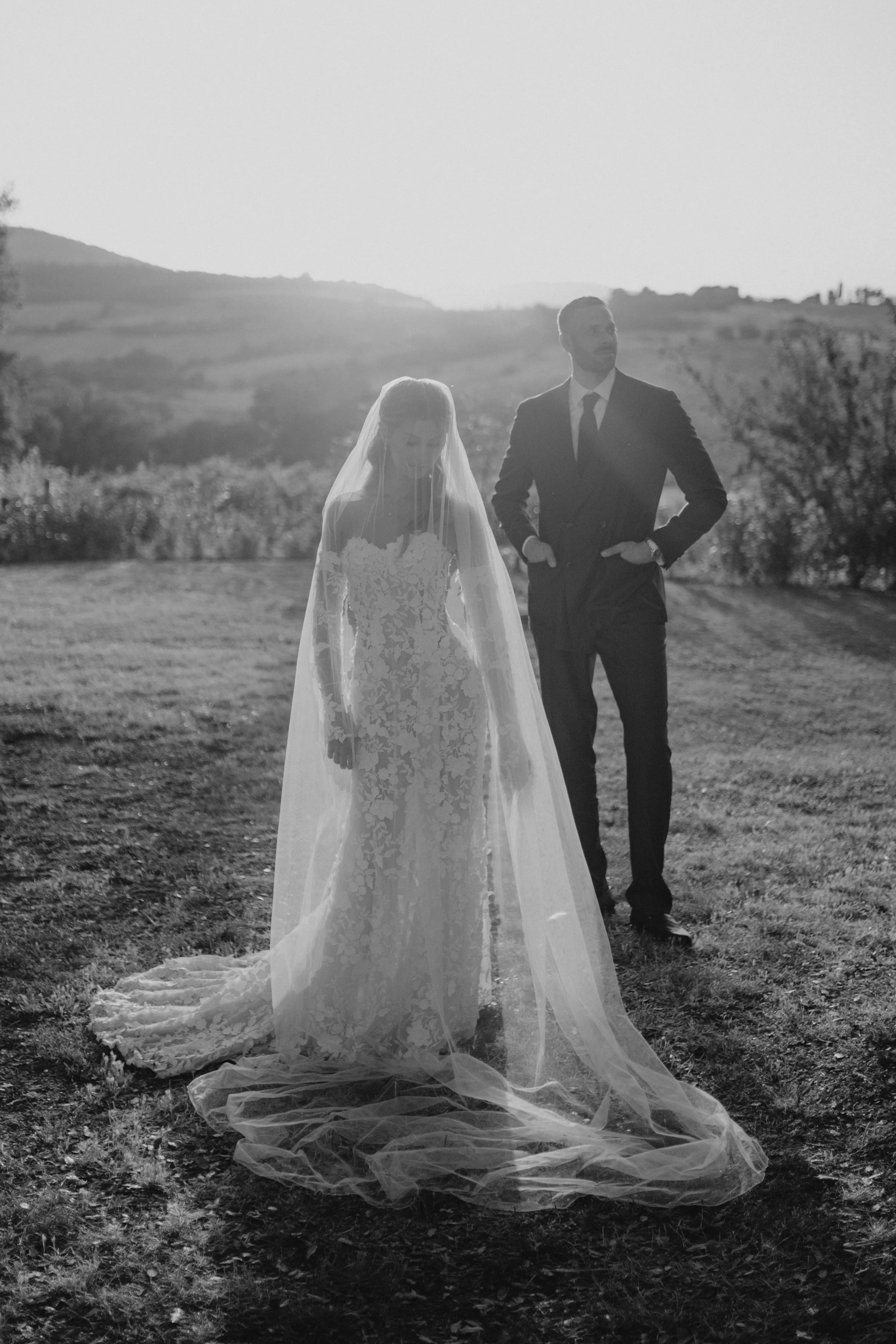 Elegant Tuscany wedding couple portraits in the warm Italian evening light, combining the rustic architecture and natural landscape of Lustignano with a timeless wedding aesthetic.