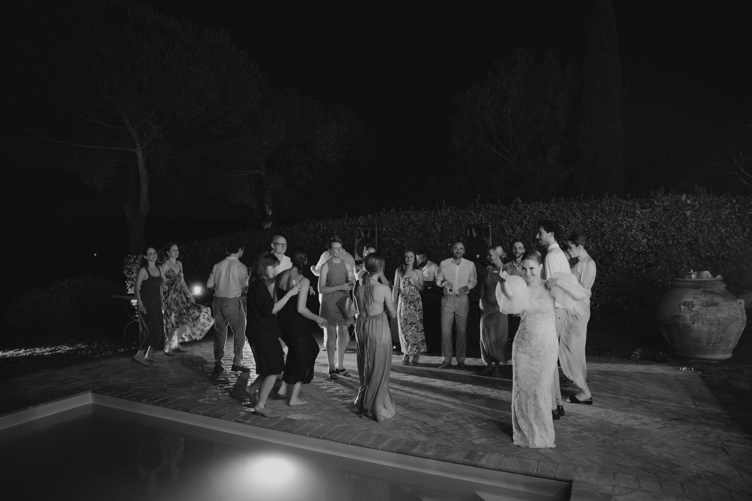 Selina, Jamie and their guests dancing, enjoying ice cream and jumping into the pool at Casale del Gallo during a relaxed Italian summer wedding party.