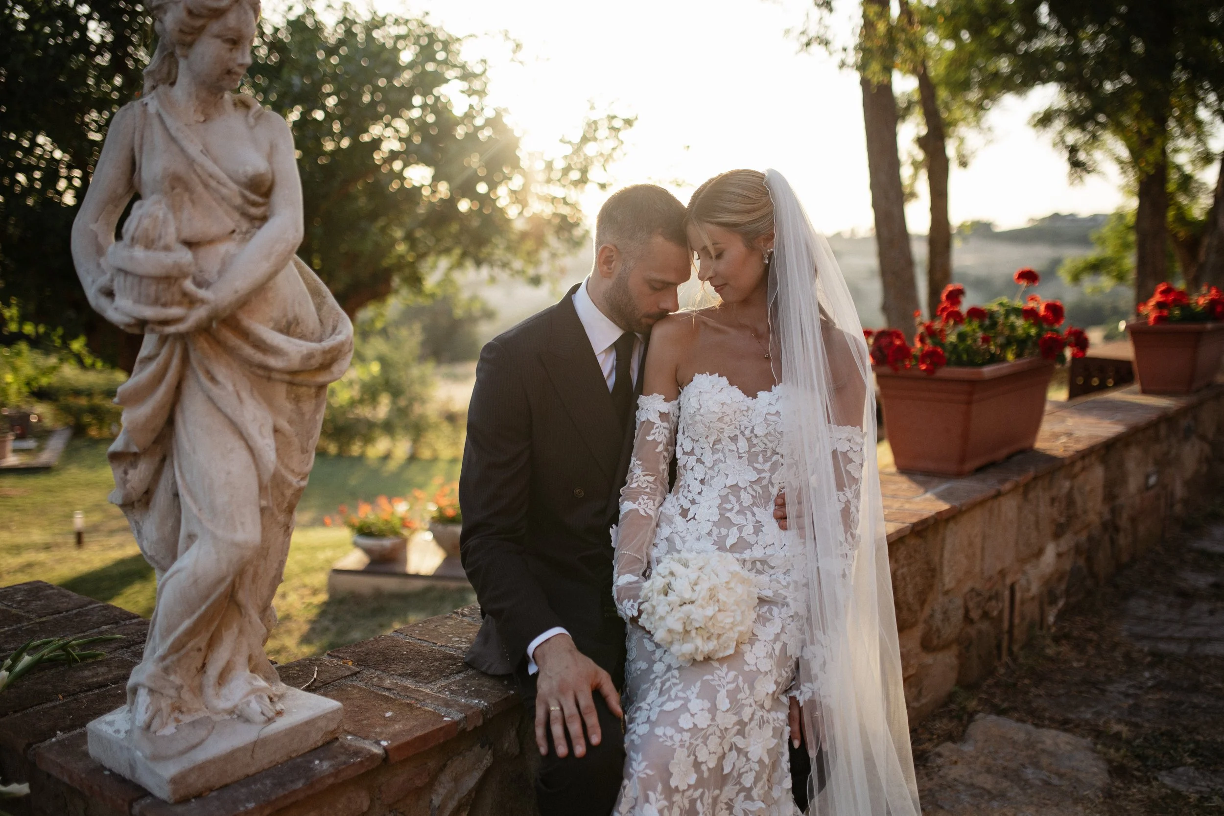Elegant Tuscany wedding couple portraits in the warm Italian evening light, combining the rustic architecture and natural landscape of Lustignano with a timeless wedding aesthetic.