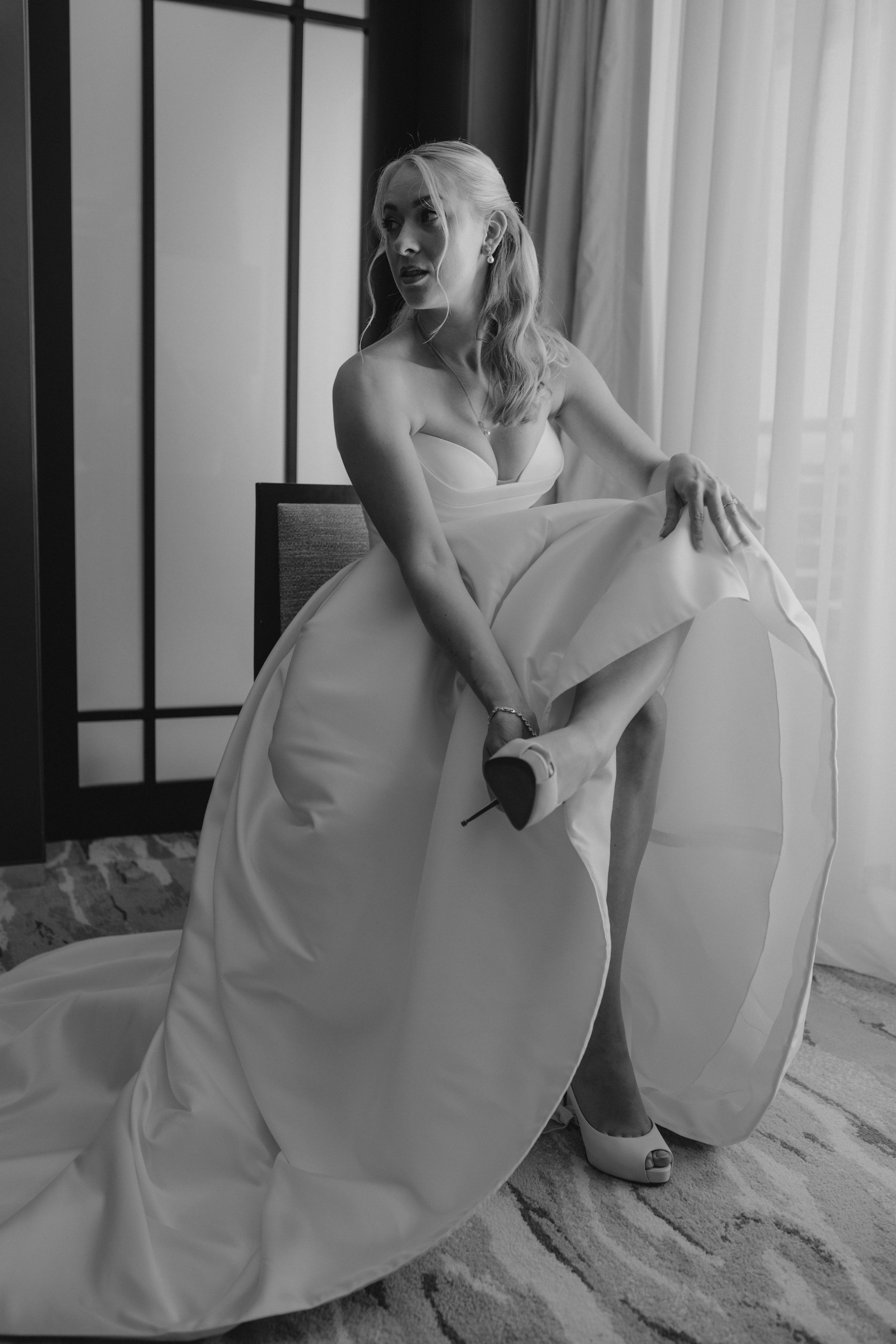 Luxury wedding getting ready at JW Marriott Cannes on the French Riviera, featuring the bride in her elegant Jarice Bridal gown, Christian Louboutin heels, refined bridal details, and a calm, modern wedding morning on the Côte d'Azur.