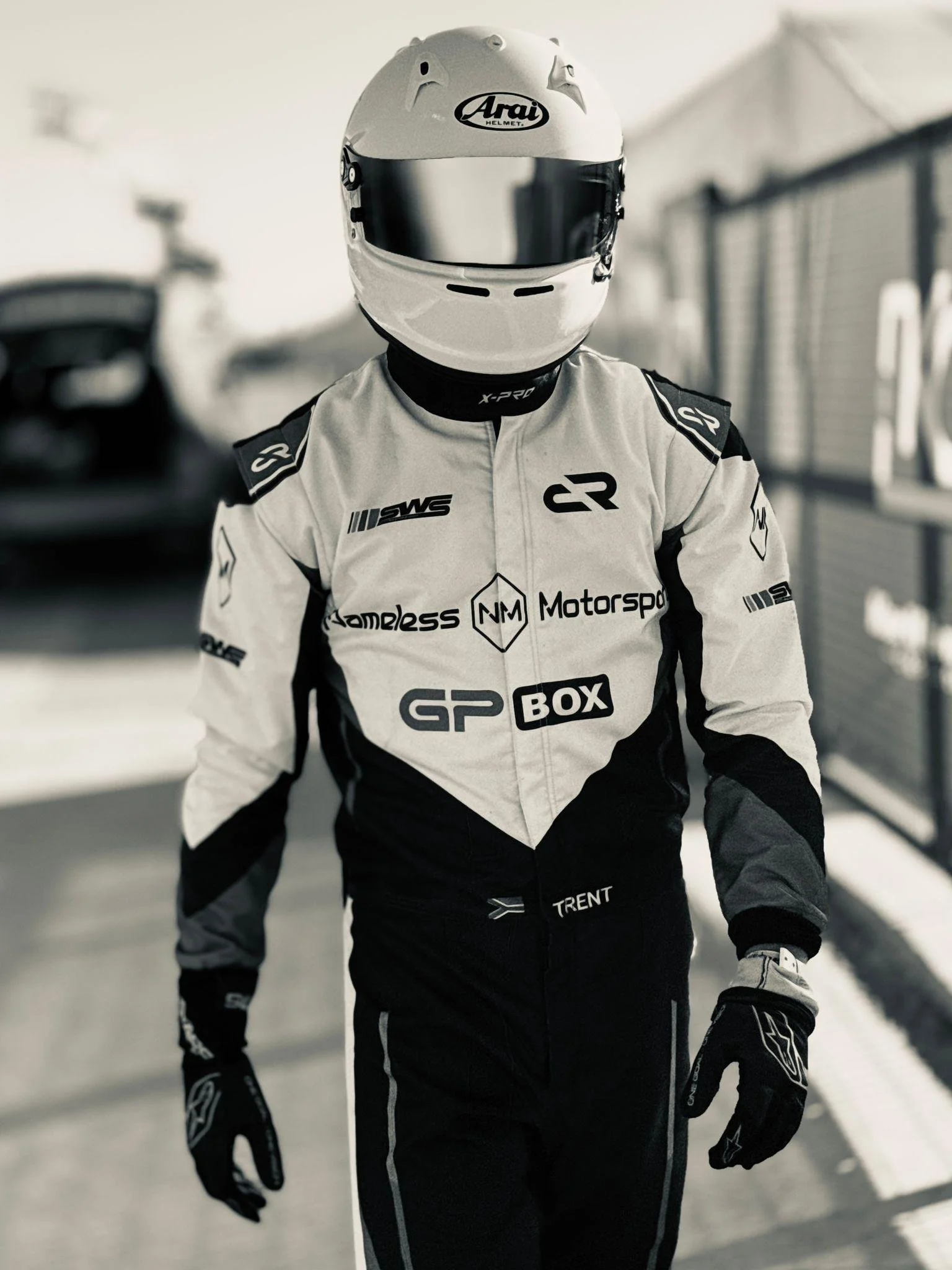 Person wearing a racing suit and helmet