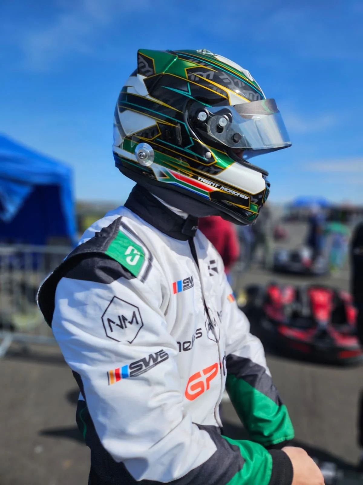 Person wearing a racing suit and helmet