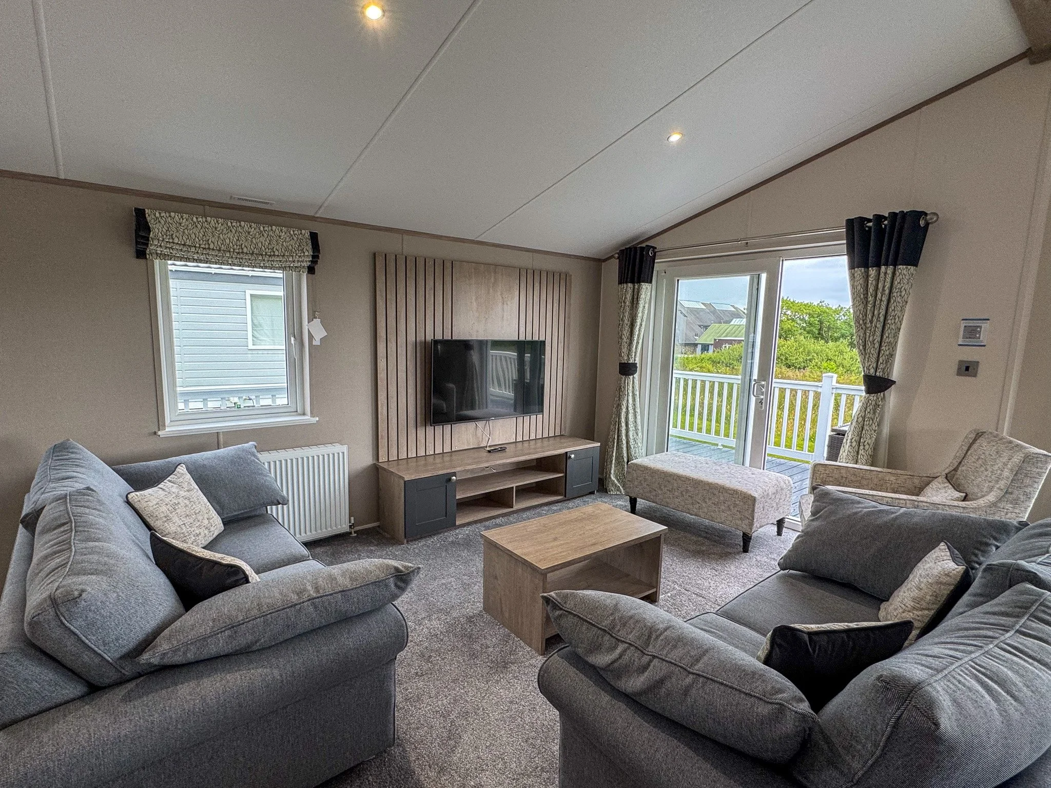Open-plan lounge inside a two-bedroom Platinum Lodge at Bodmin Holiday Park in Cornwall.