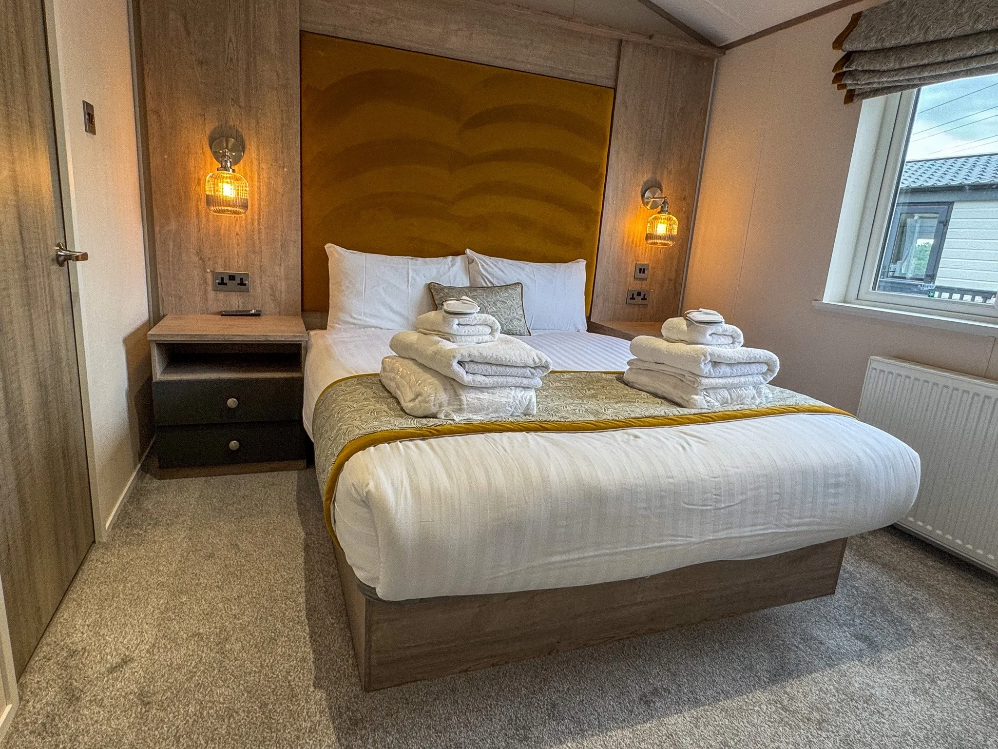 Master bedroom inside a two-bedroom Platinum Lodge at Bodmin Holiday Park in Cornwall.