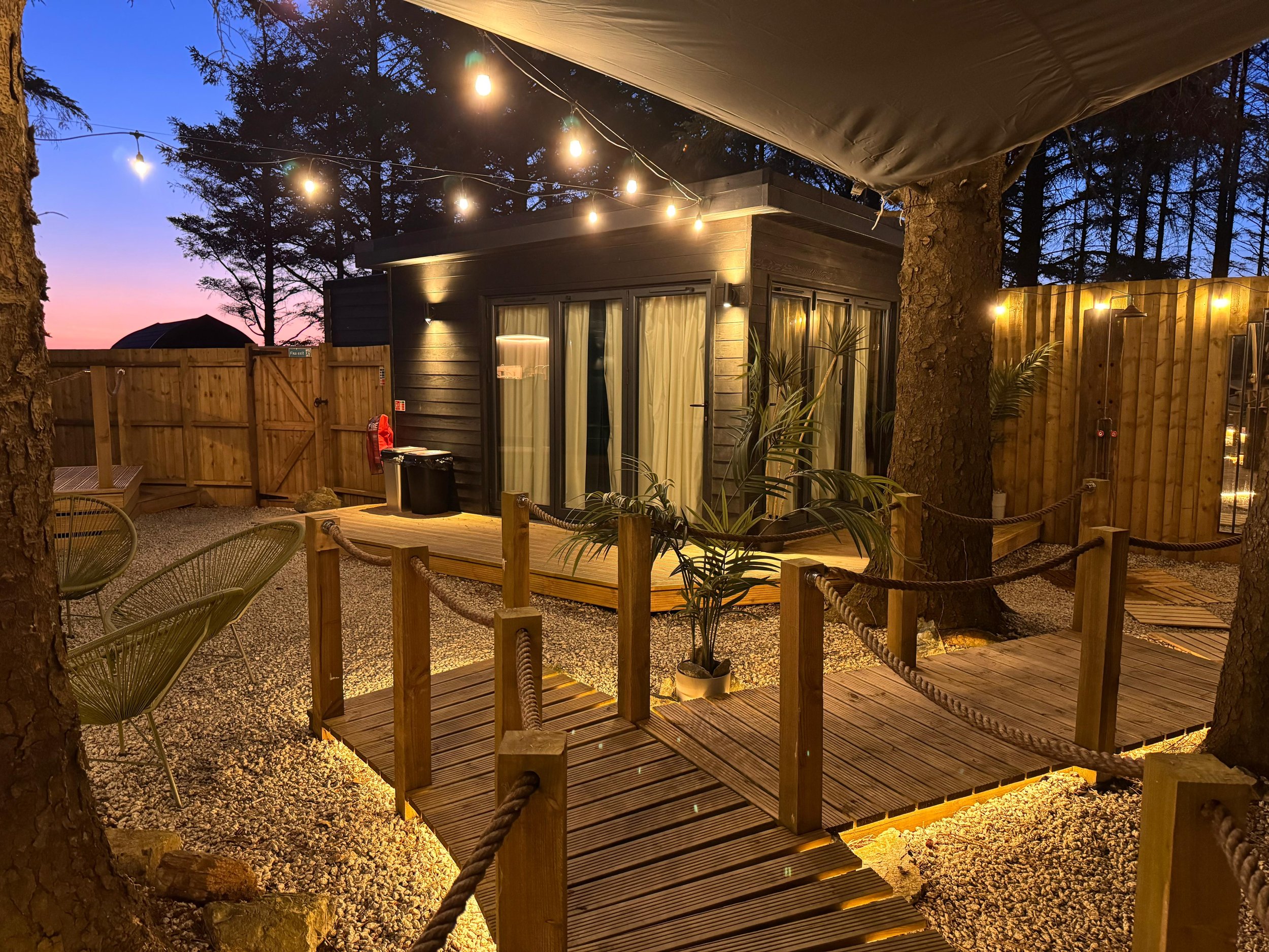 Secret Garden Glamping Cornwall outdoor space at night with twinkling lights and cosy atmosphere
