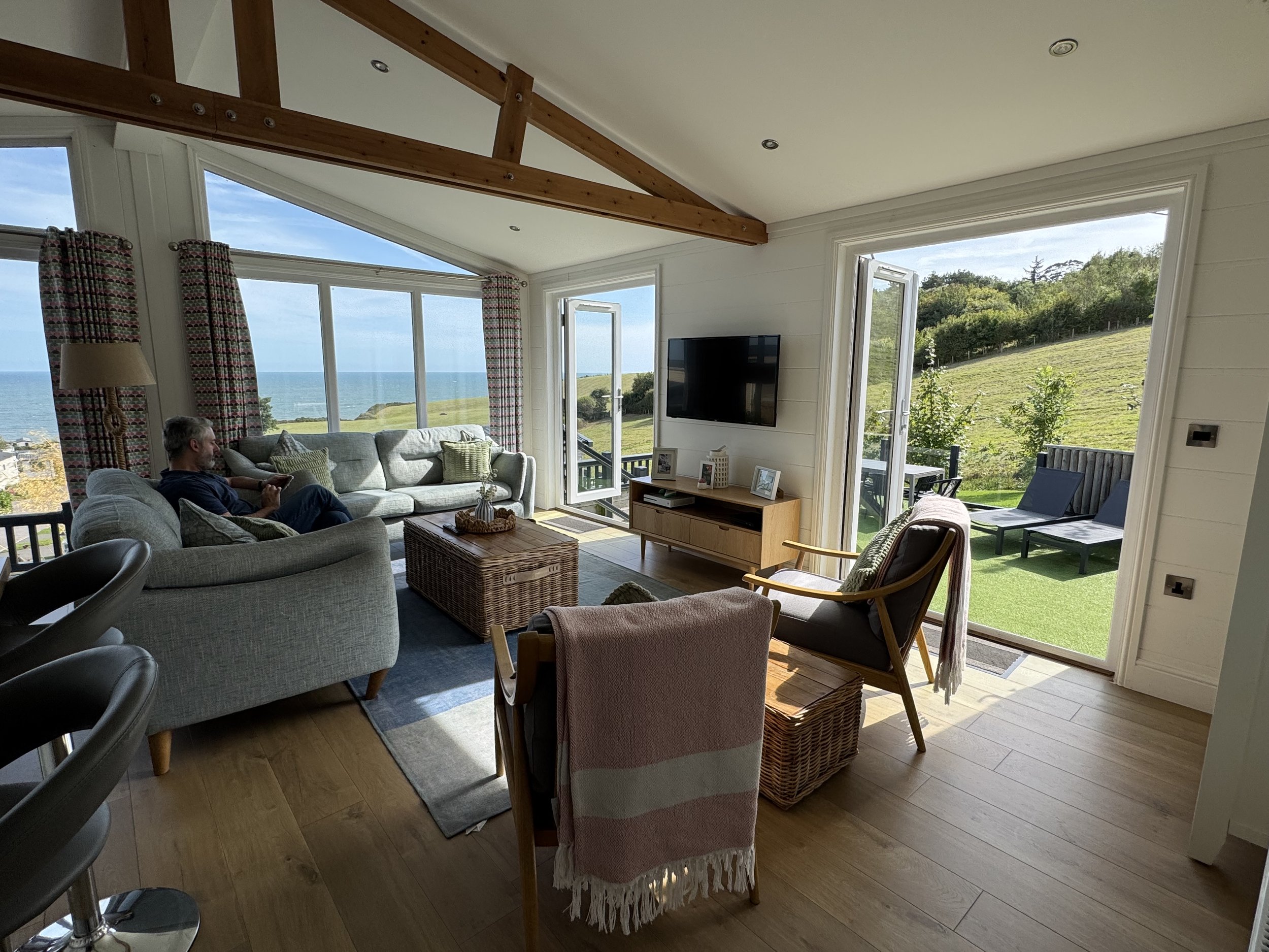 Open-plan lounge at Rockpool Lodge with sea views at Ladram Bay Holiday Park in East Devon