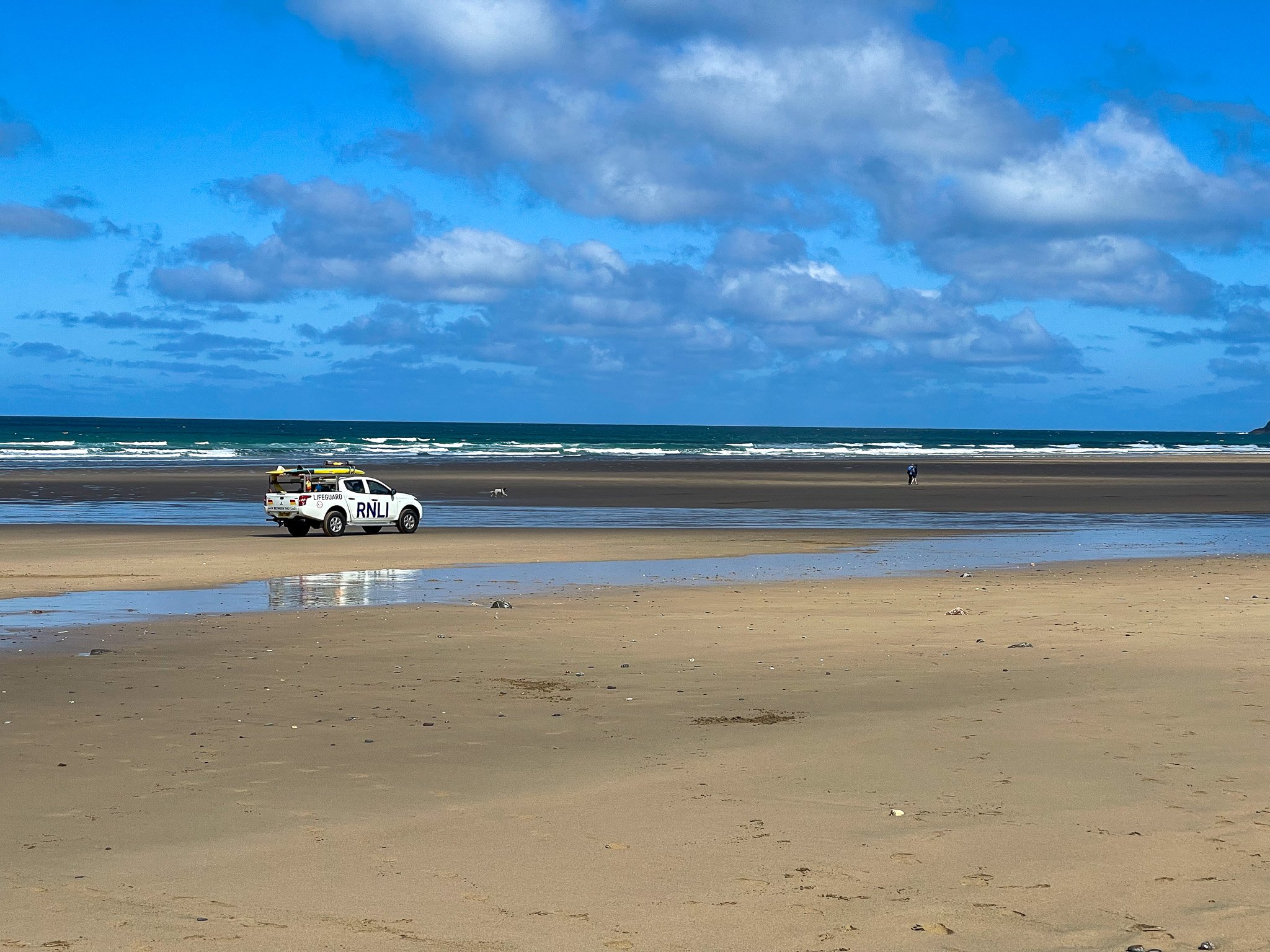 RNLI lifeguard patrol truck on Perranporth Beach in Cornwall